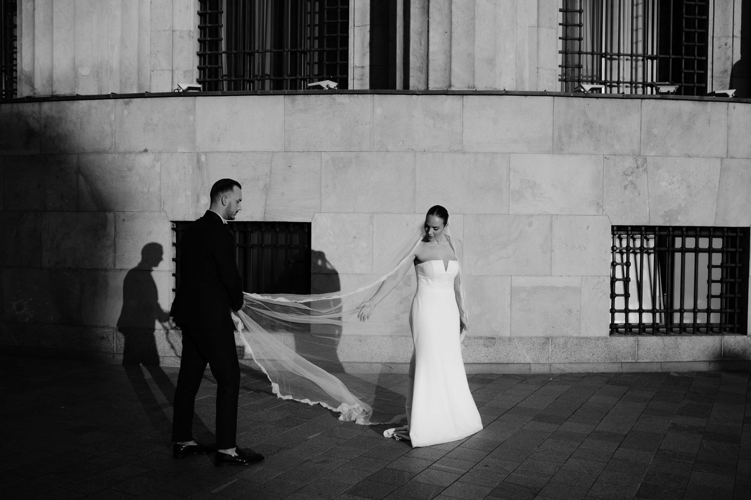 A black and white photo strip shows six sequential wedding moments in front of a stone building.
