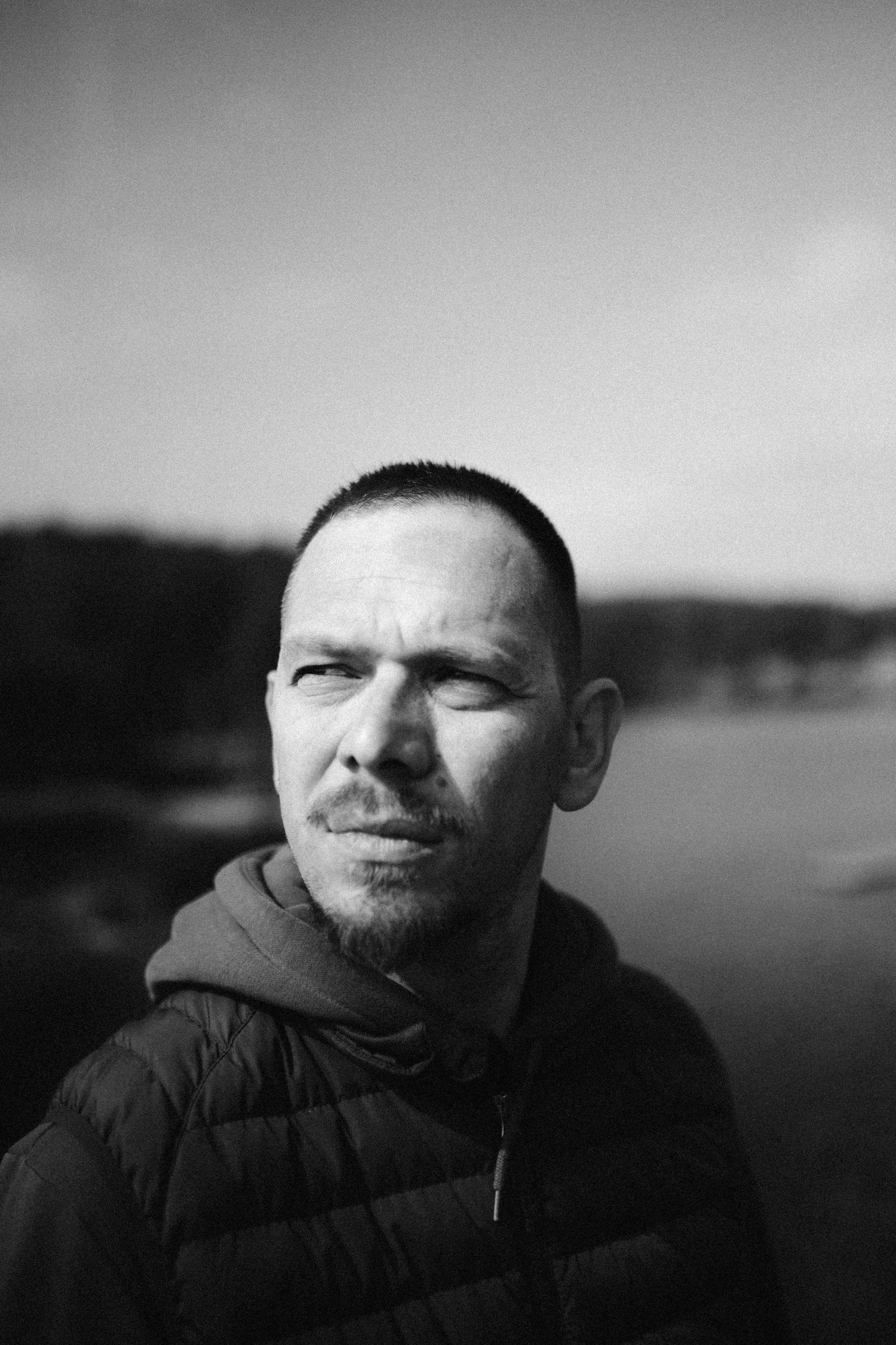 A black and white photo sequence showing a person's face with closed eyes and dark clothing against a blurred background.