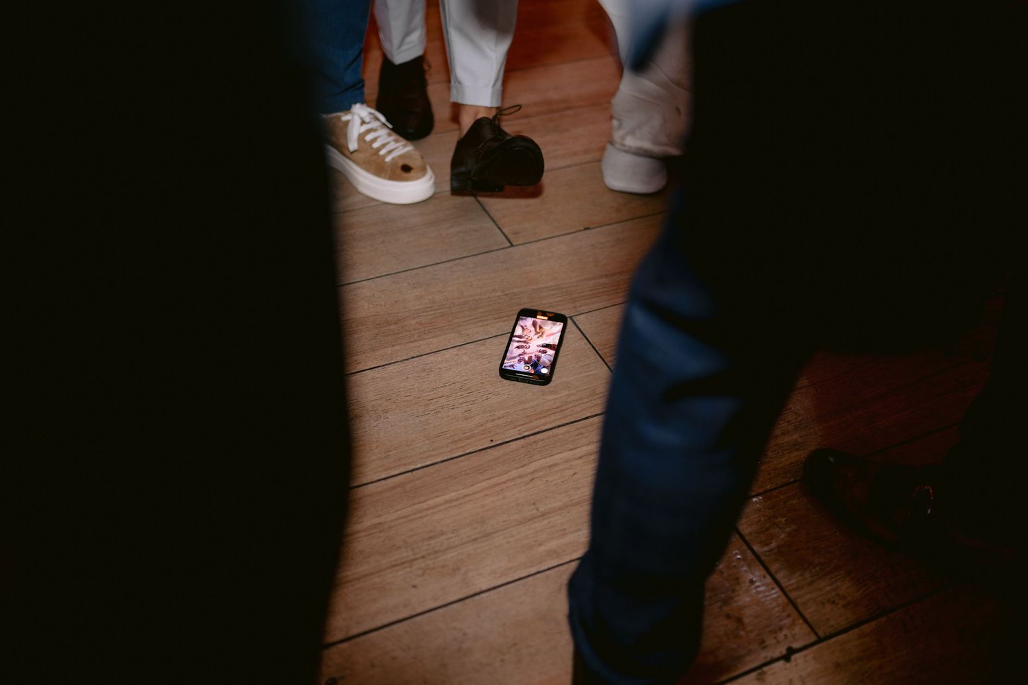People dancing together on a wooden floor during what appears to be a social dance gathering or event.