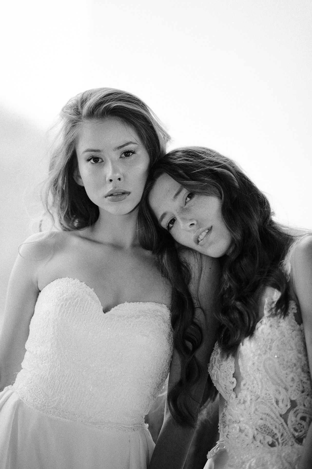 Romantic bridal portrait series featuring white lace dresses in soft natural light.
