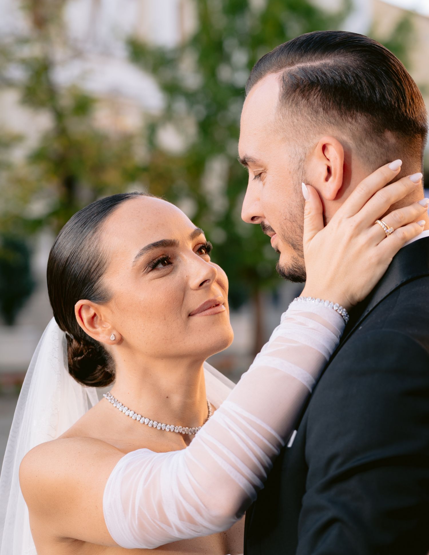 A romantic wedding couple shares intimate moments in a series of tender poses outdoors.