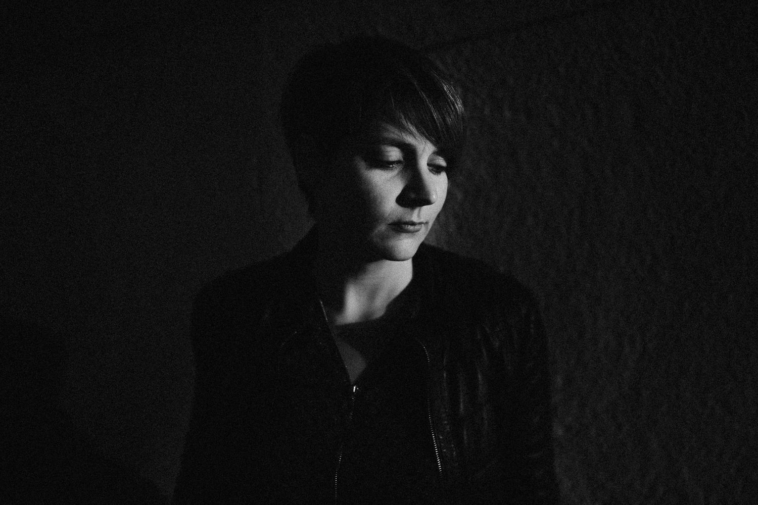 Dramatic black and white portrait with strong shadows and contrast.