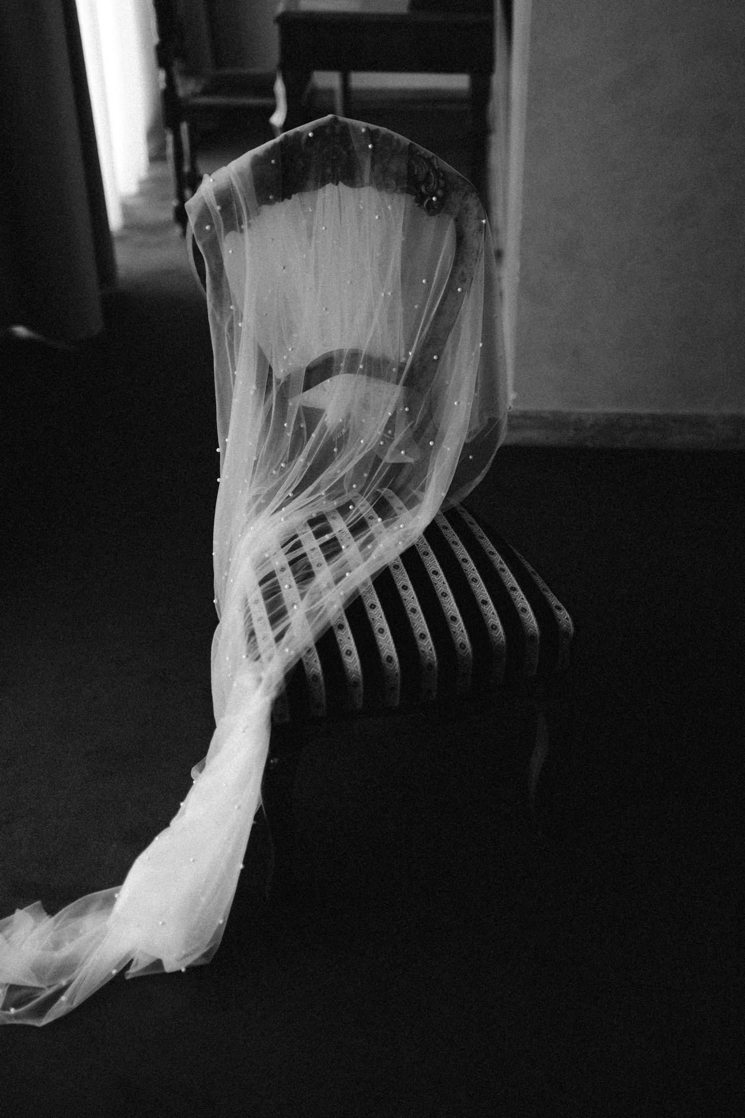 Artistic black and white detail of flowing wedding veil fabric.