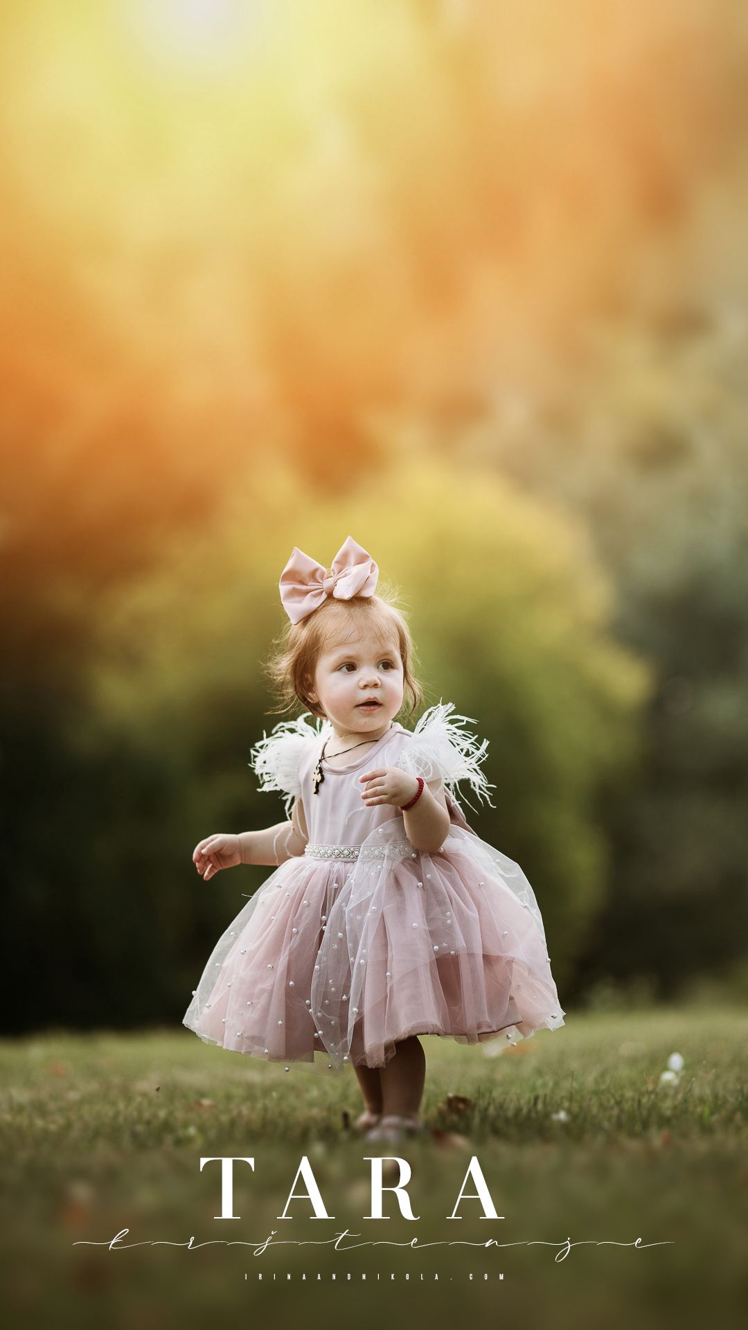 Little girl in pink tulle dress twirling in golden sunset light.