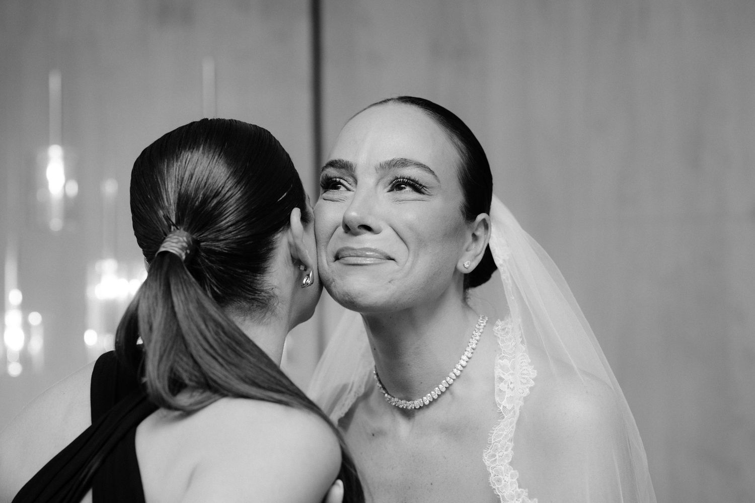 A tender black and white wedding moment captured between two people as they share an intimate exchange.