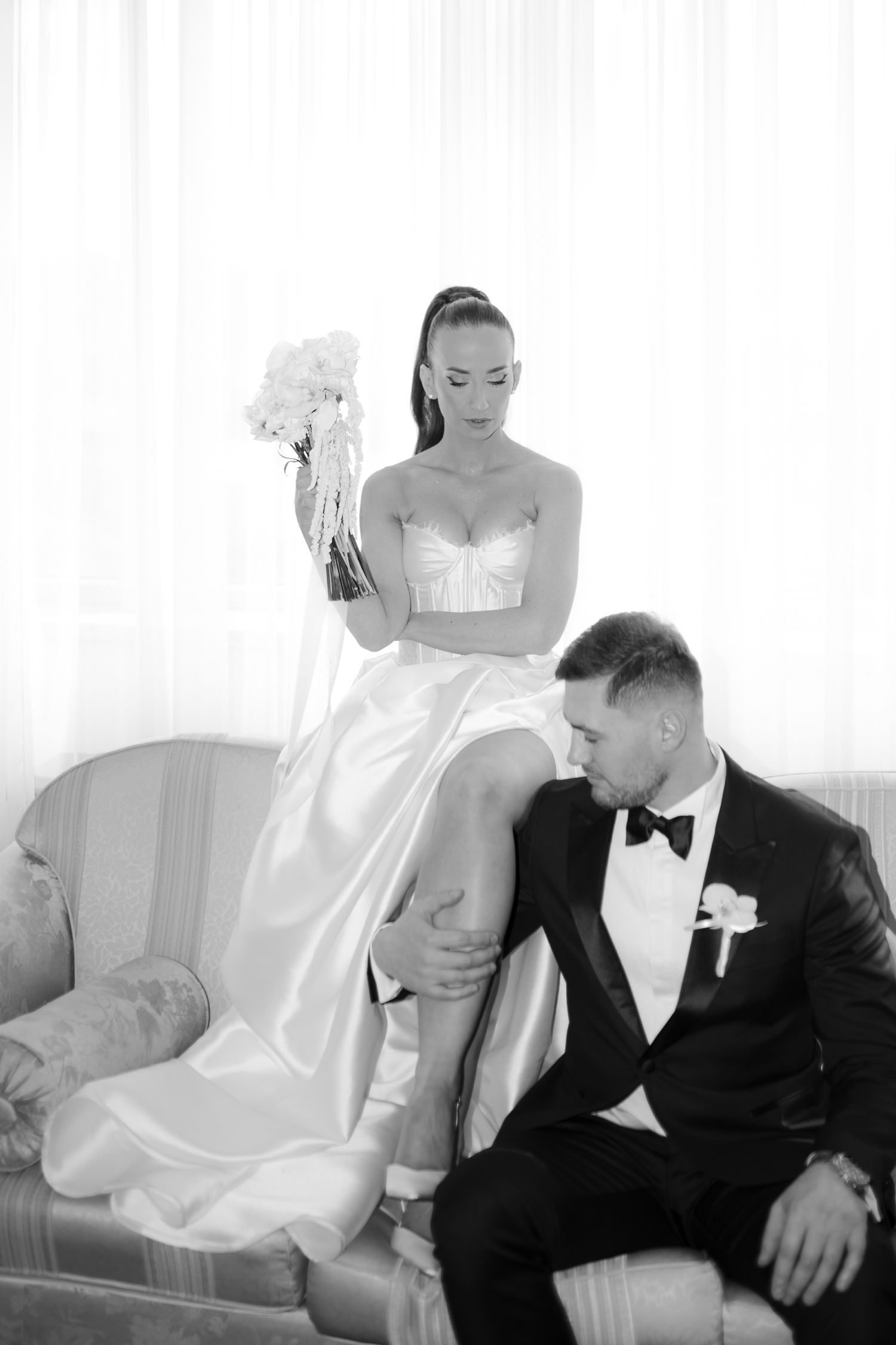 A romantic black and white photo series shows intimate moments between a bride and groom sitting together.