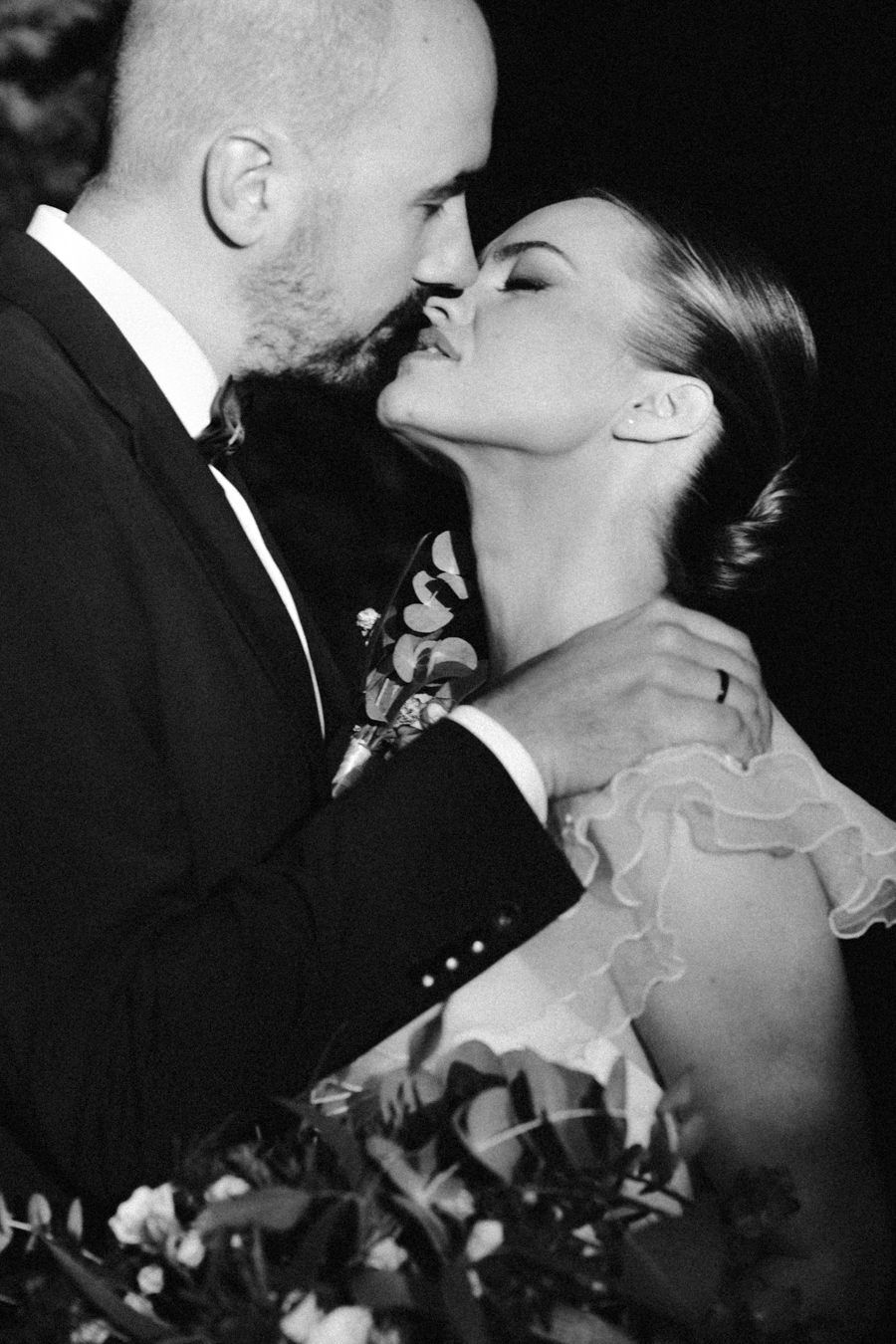 Romantic black and white portrait of a couple sharing an intimate moment at their wedding.