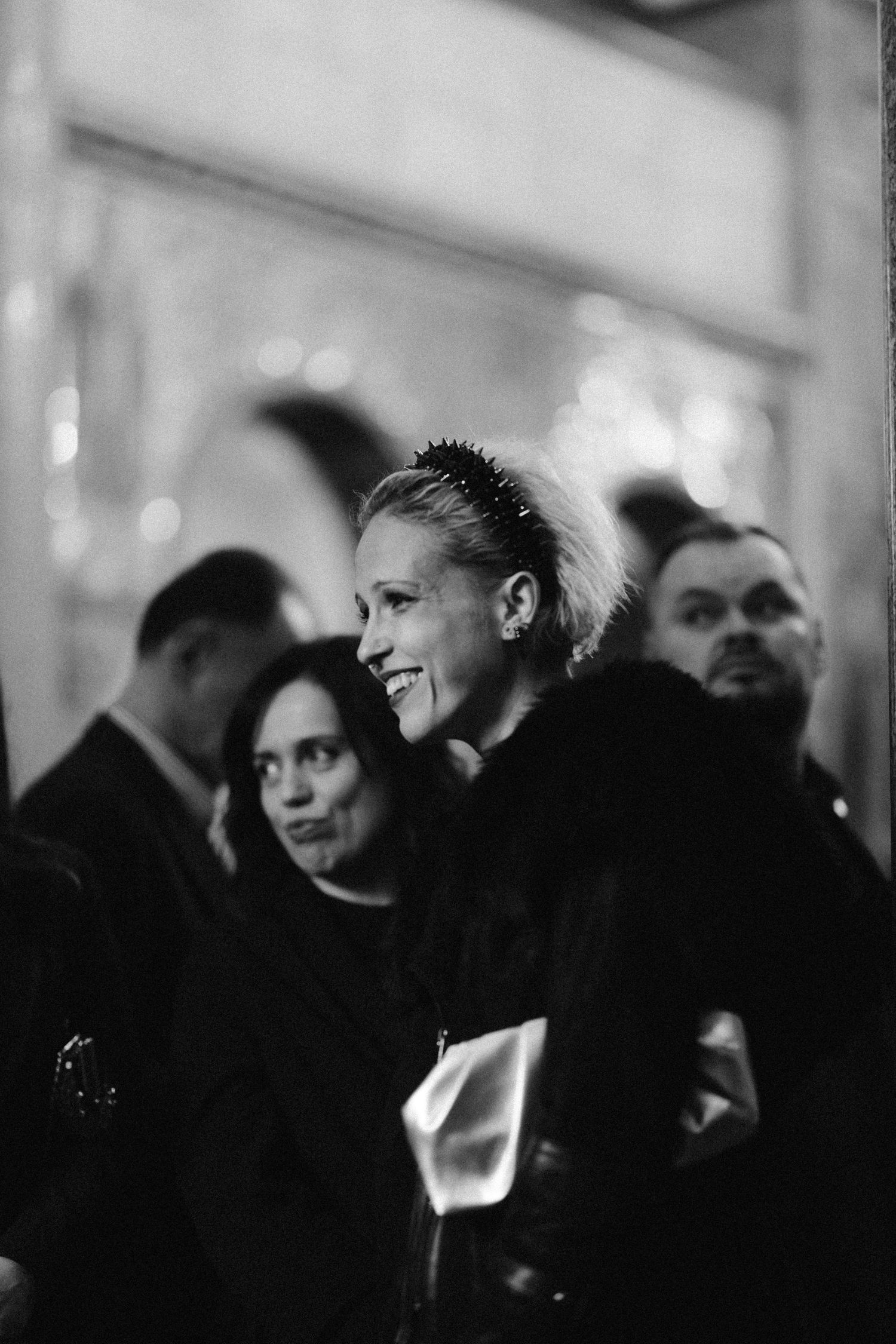 Black and white candid shot of people at formal event showing genuine emotion.