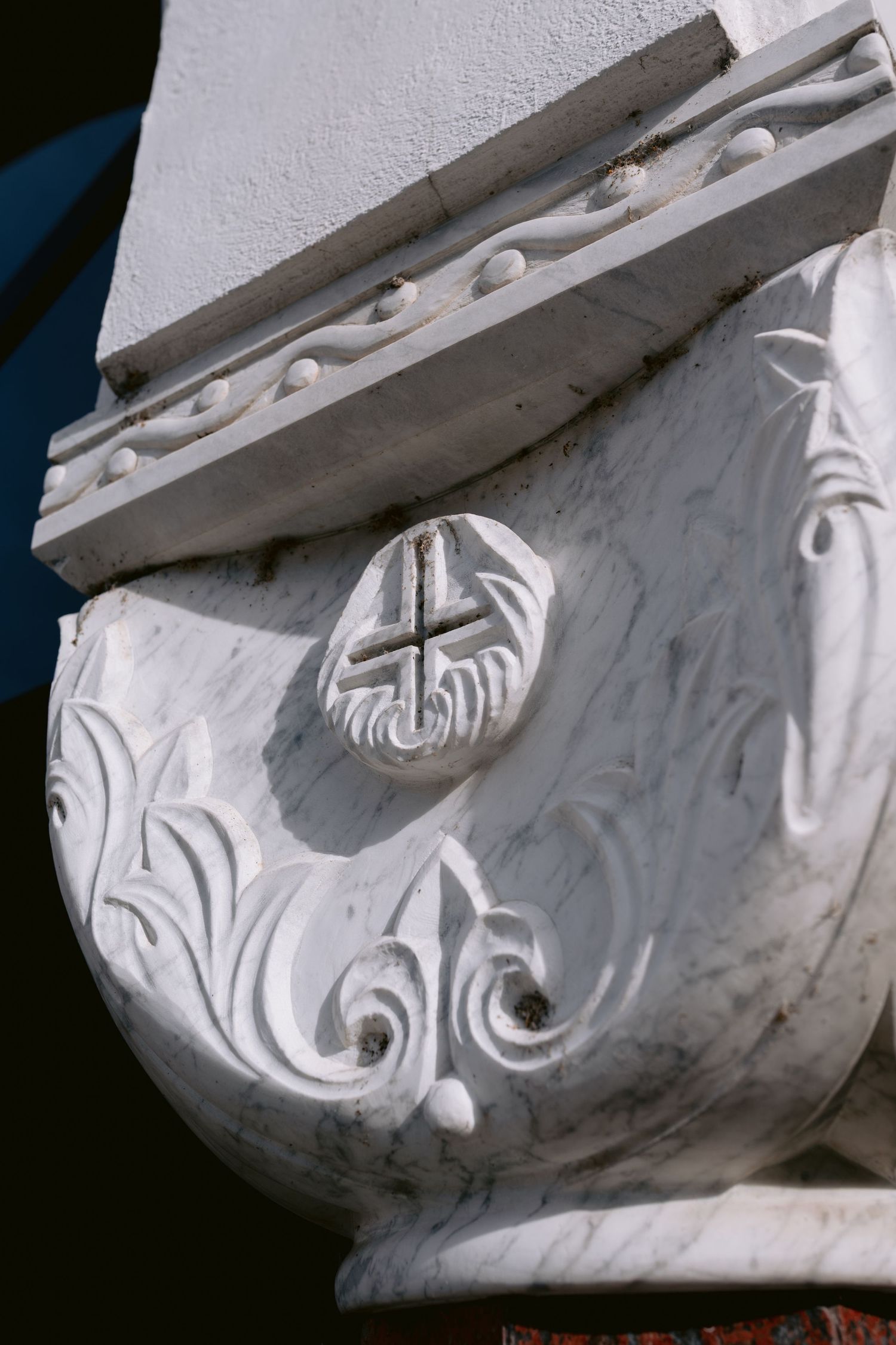 Ornate white architectural detail showing decorative scrollwork and molding patterns.