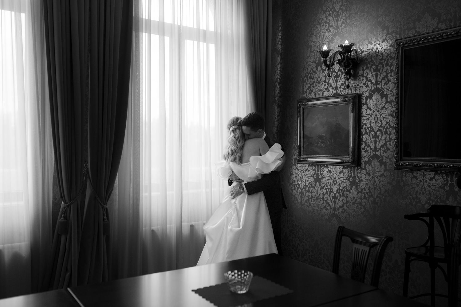 Artistic black and white wedding photos showing silhouettes against bright windows.