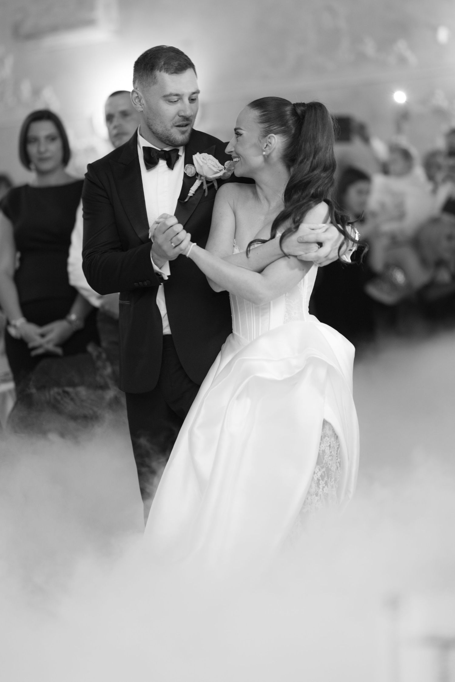 A romantic first dance at a wedding reception with fog effects creating a dreamy atmosphere on the dance floor.