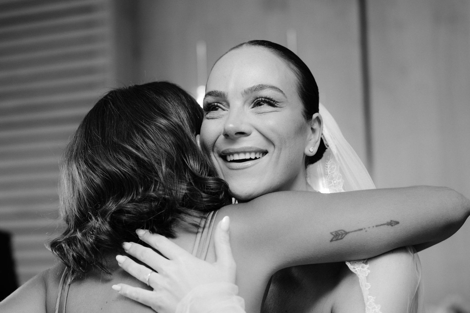 A series of black and white photos showing two people embracing in joyful celebration.