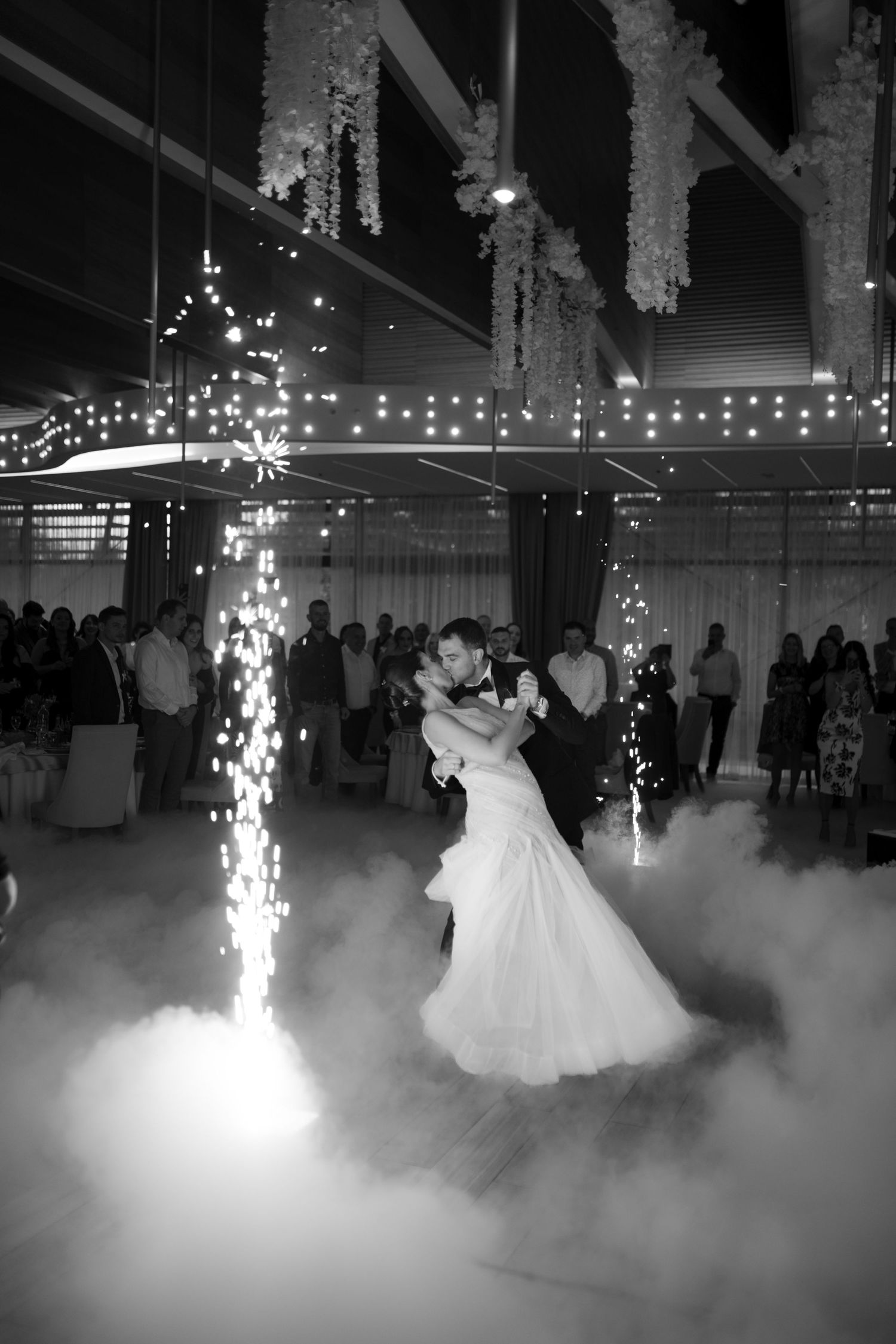 First dance at wedding reception with dramatic fog effects and sparkler fountains.