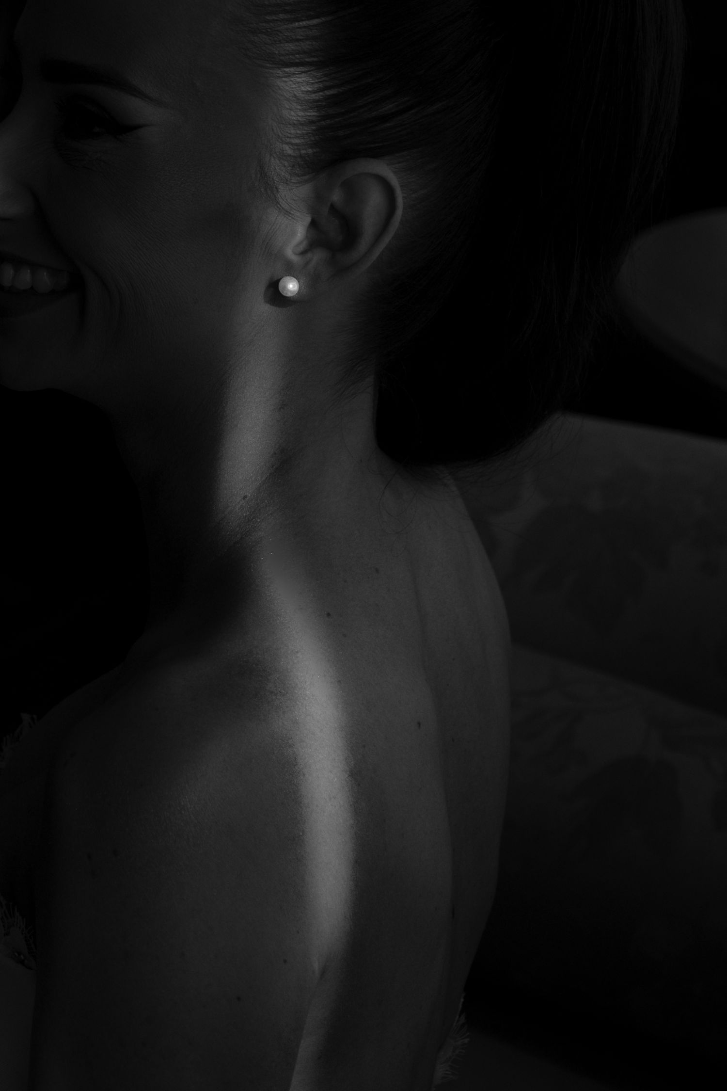 A series of black and white artistic photographs showing close-up details of a neck and shoulders in dramatic lighting.