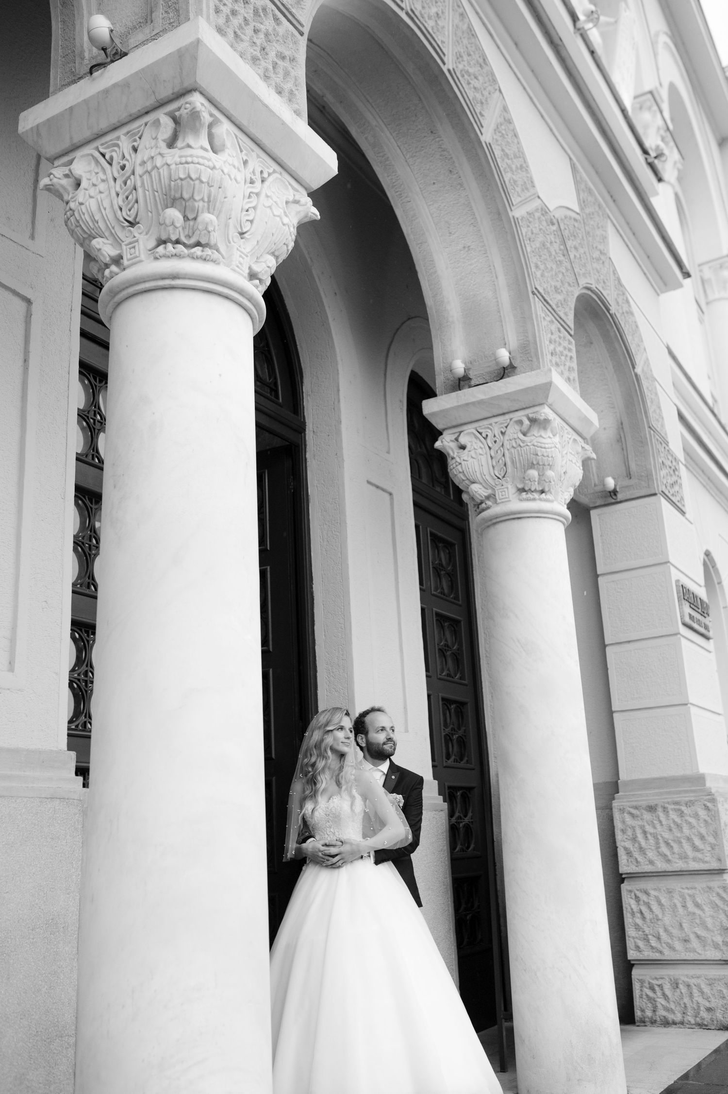 Classic white columns and architectural details create an elegant wedding venue backdrop.