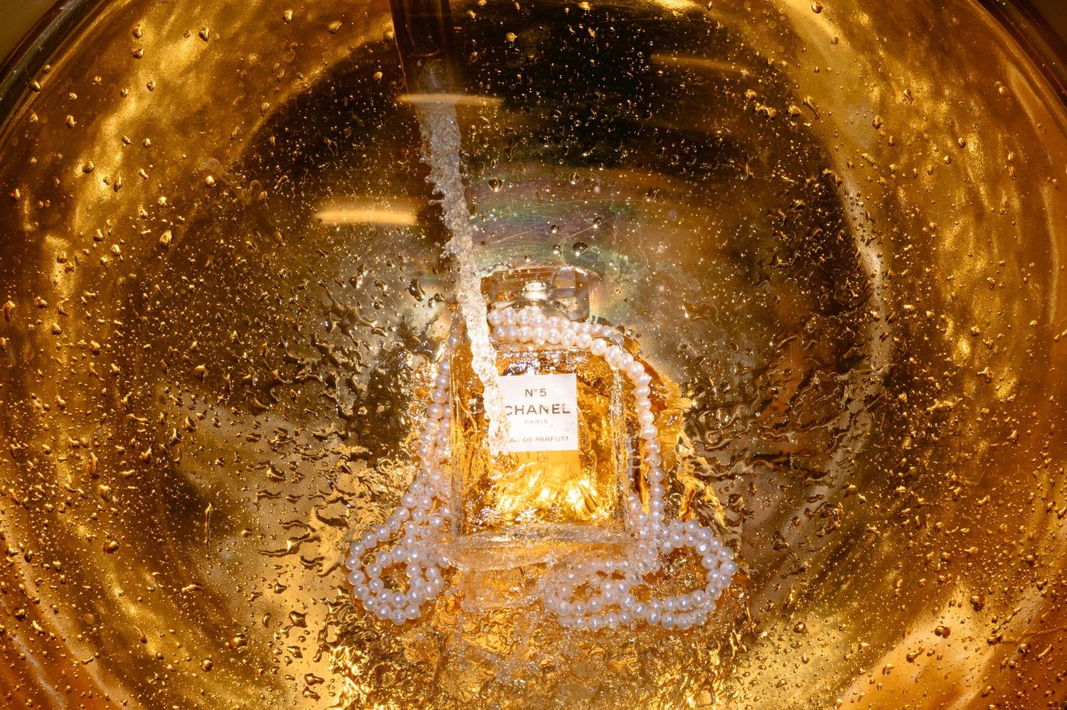 Champagne being poured into a glass creating a golden swirl of bubbles and reflections.