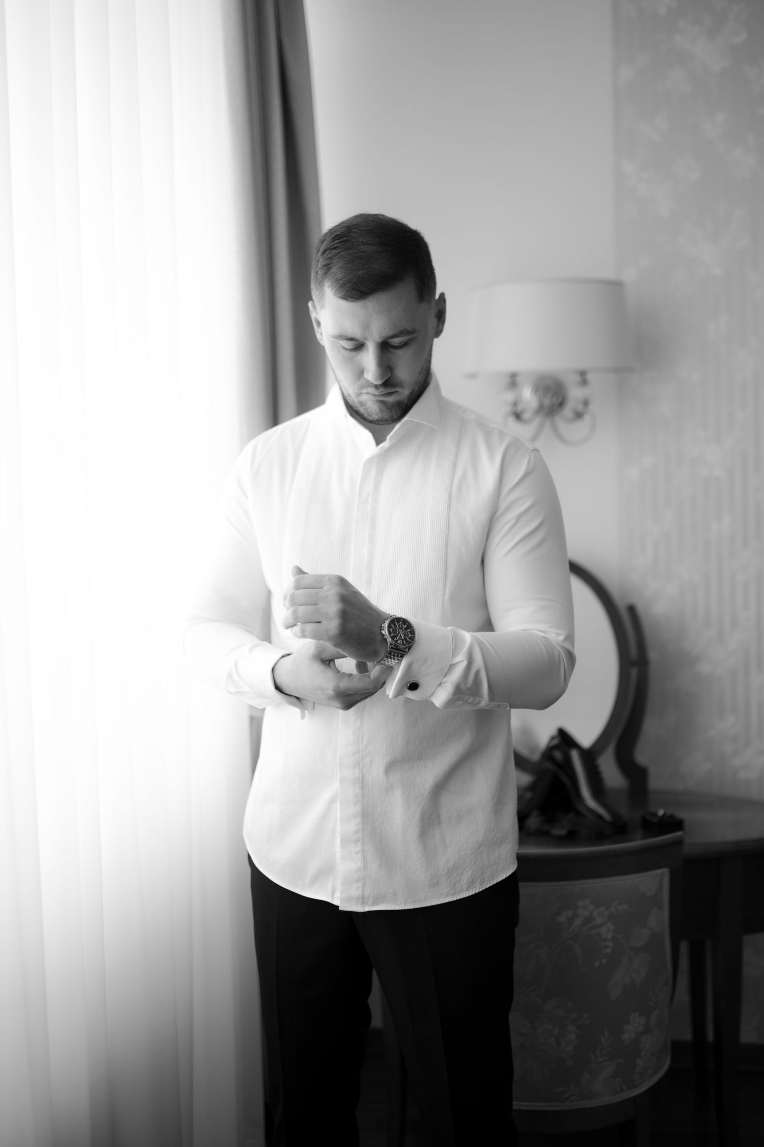 Black and white photos of wedding preparation showing details of formal attire.