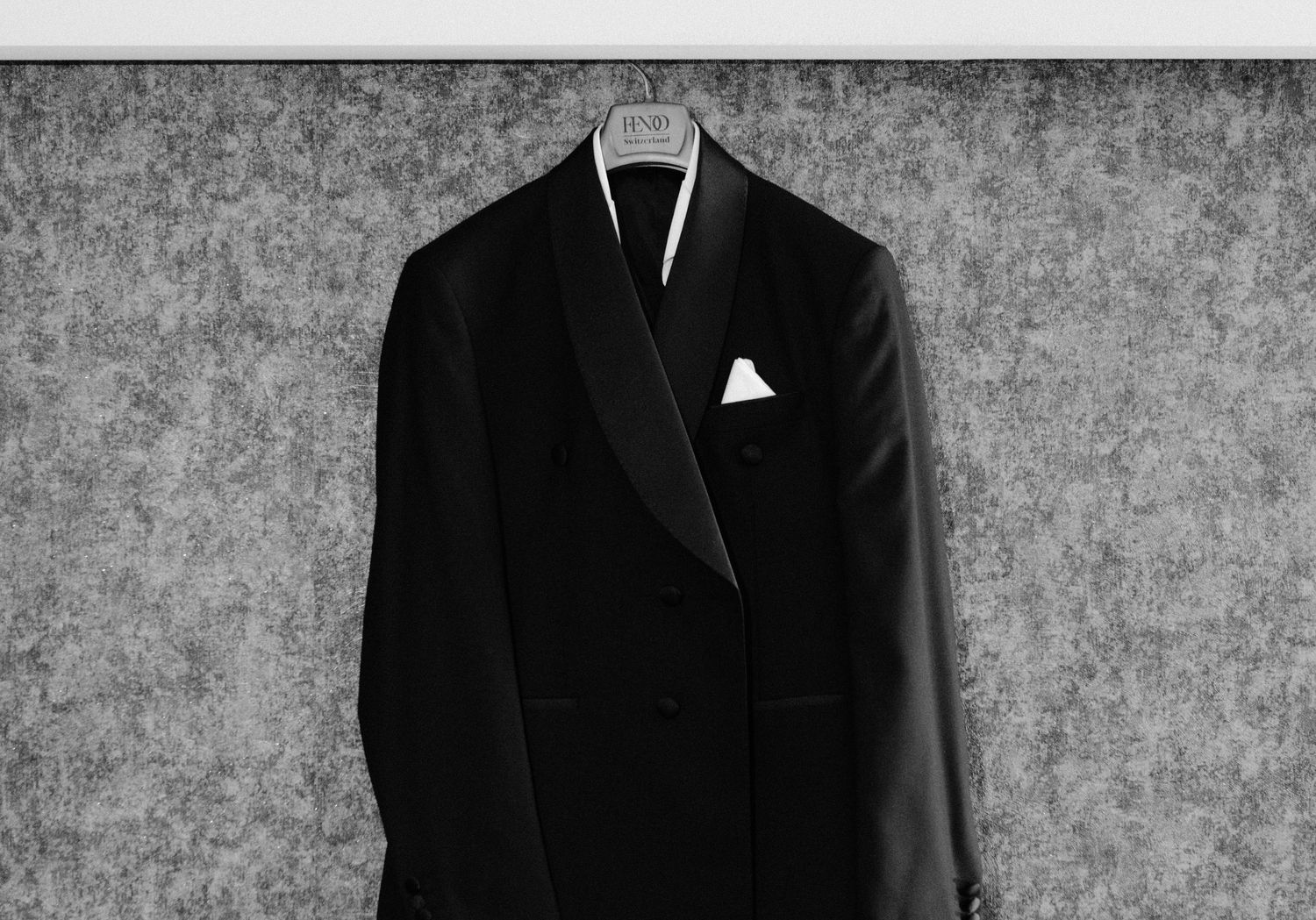 A series of black and white photographs showing a person in formal attire against a textured background.