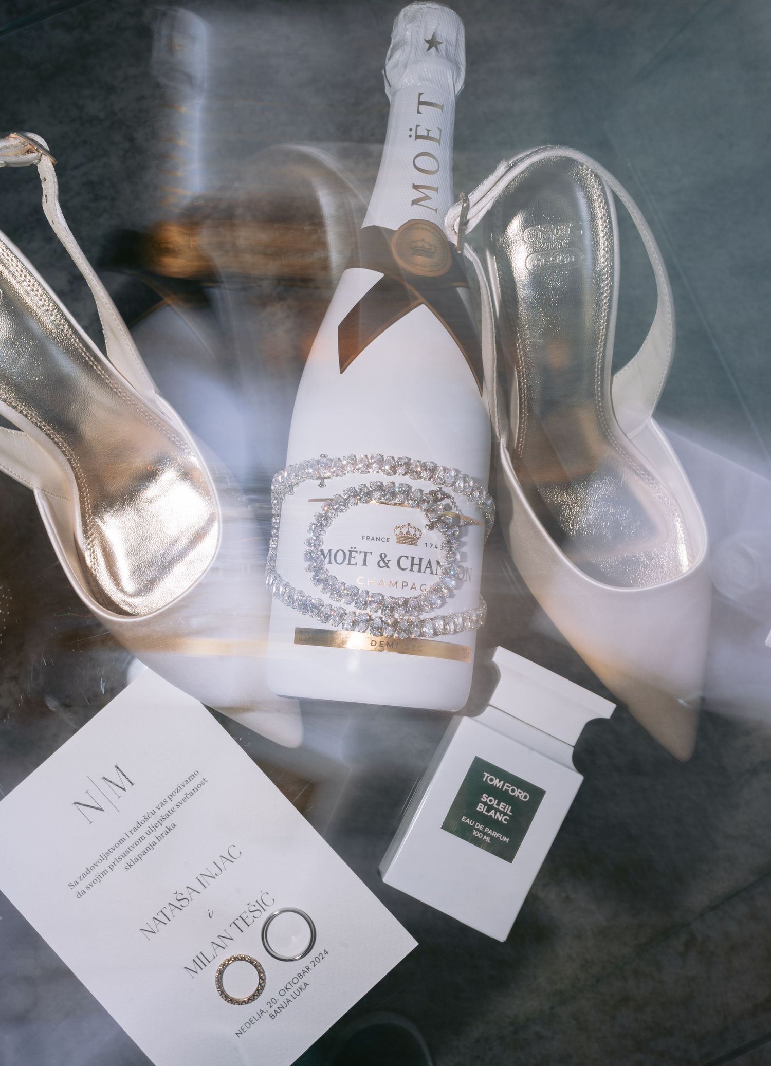 Multiple bottles of Moet Chandon champagne arranged in an artistic composition with soft lighting and white labels.