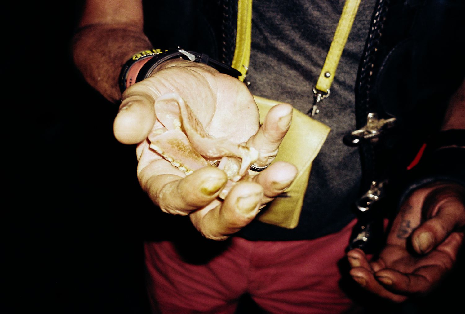 A series of close-up shots showing hands holding a yellow measuring tape against a dark background.