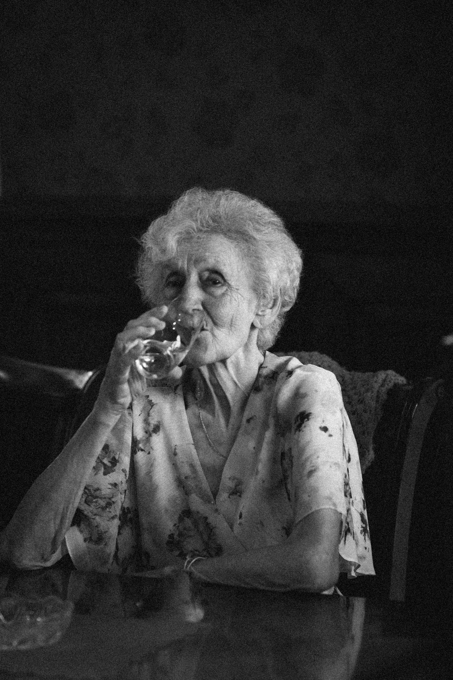A sequence of black and white photos showing someone drinking from a glass in progressive motion.