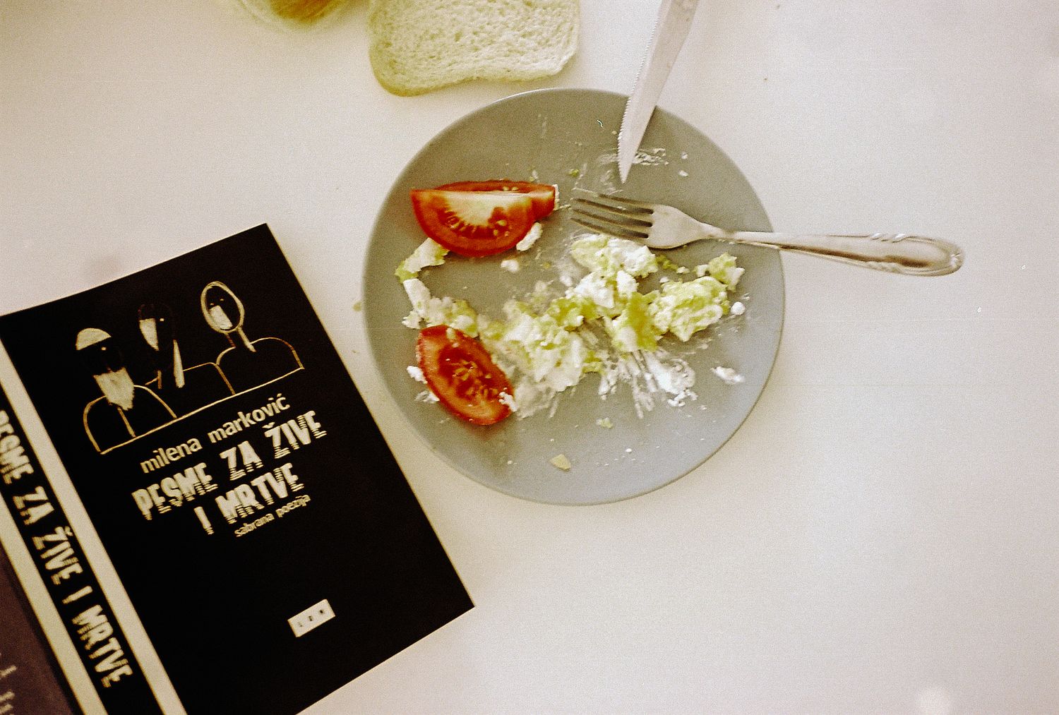 Popcorn and wine glasses arranged on a table next to black event tickets for an elegant movie screening setup.
