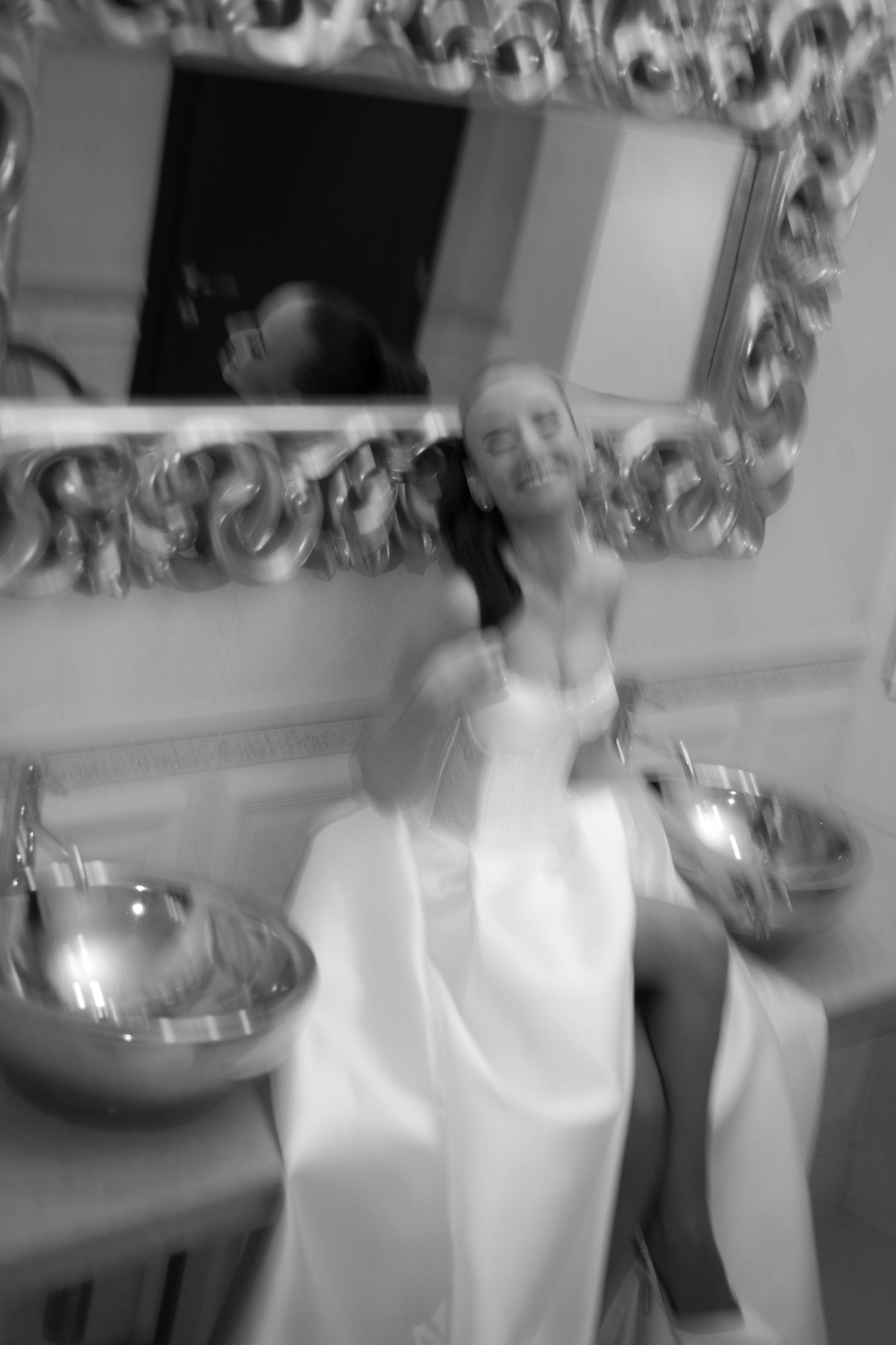 Black and white photo sequence showing motion blur of someone moving in a kitchen setting.