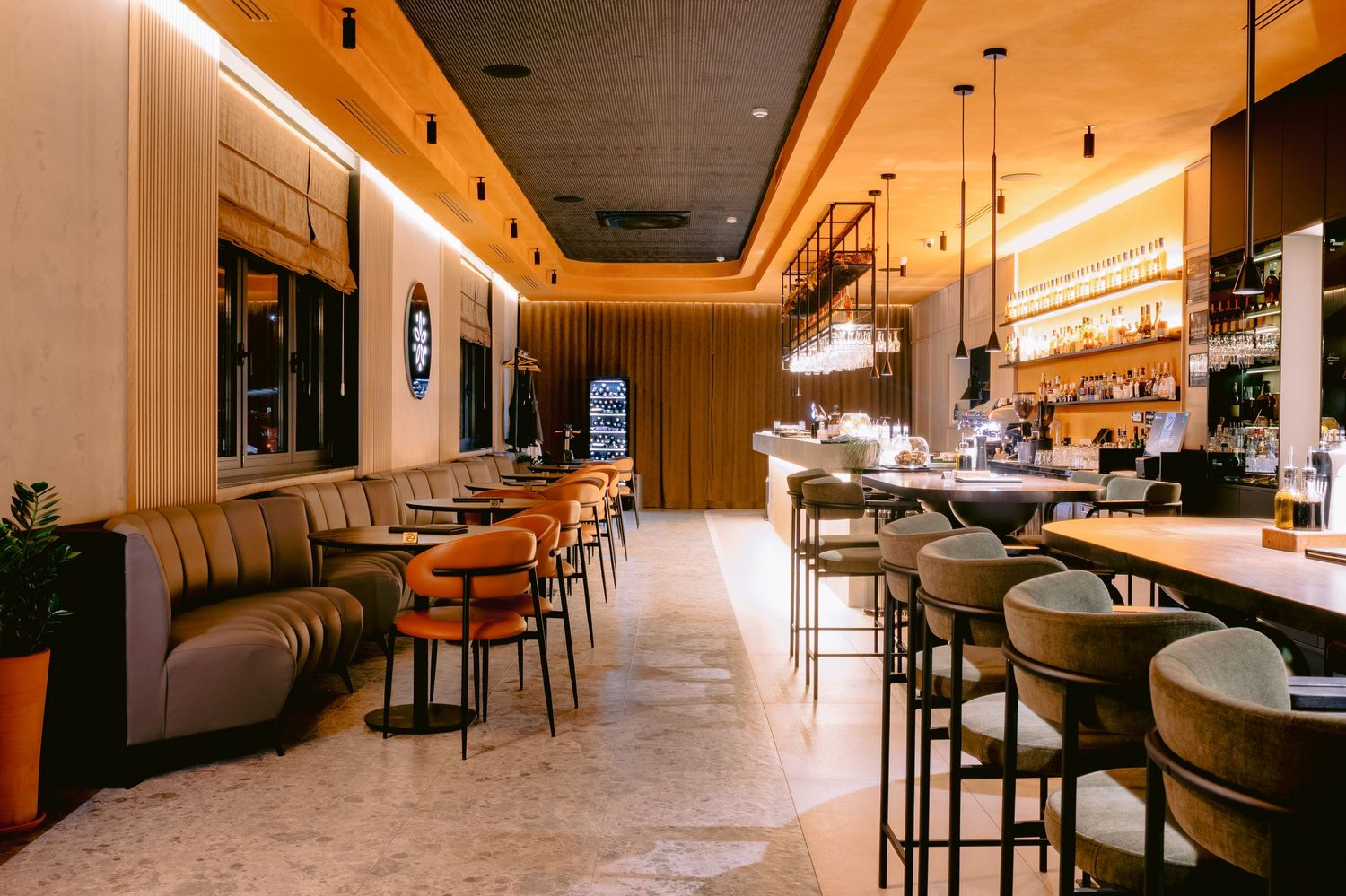 Modern restaurant interior with sleek furniture and ambient lighting creating an upscale atmosphere.