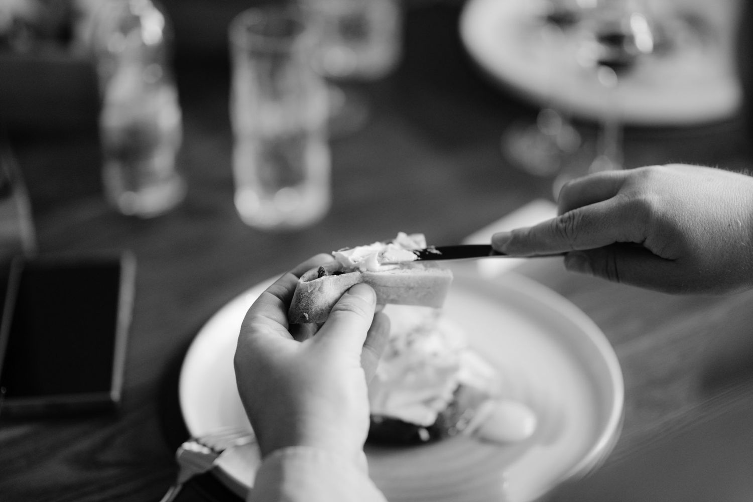 Black and white image of dining service in progress at restaurant.