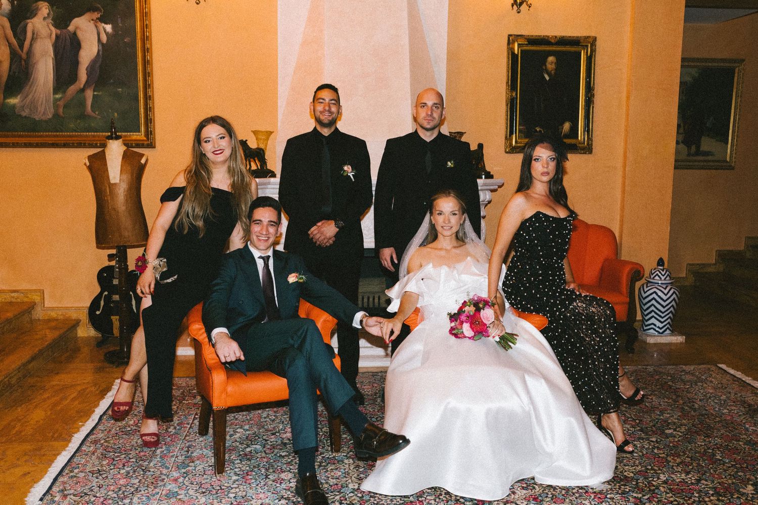 A sequence of wedding photos showing a playful couple and wedding party jumping and posing in a warm-lit indoor venue.