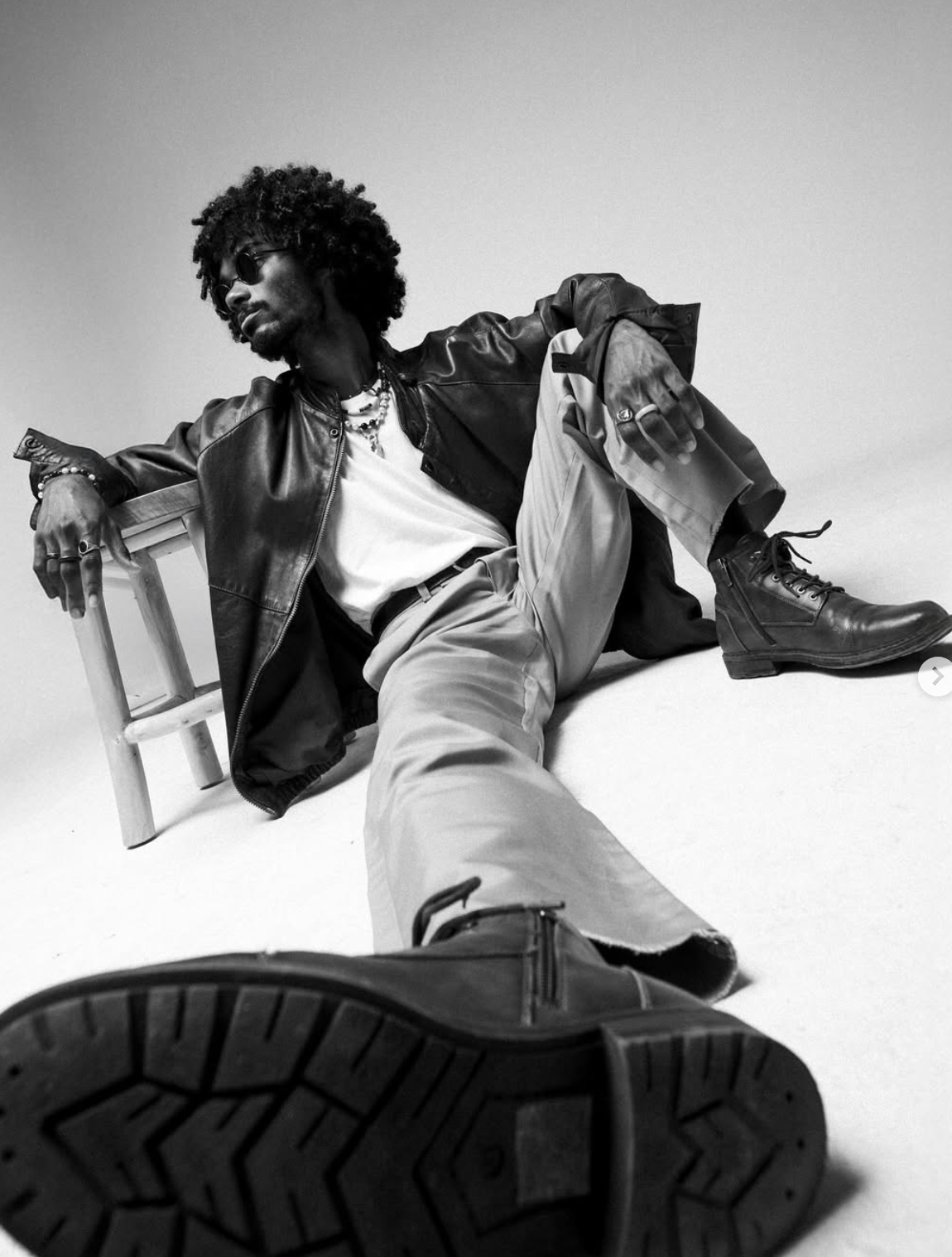 Dynamic black and white fashion shots showing movement with boots and casual wear.