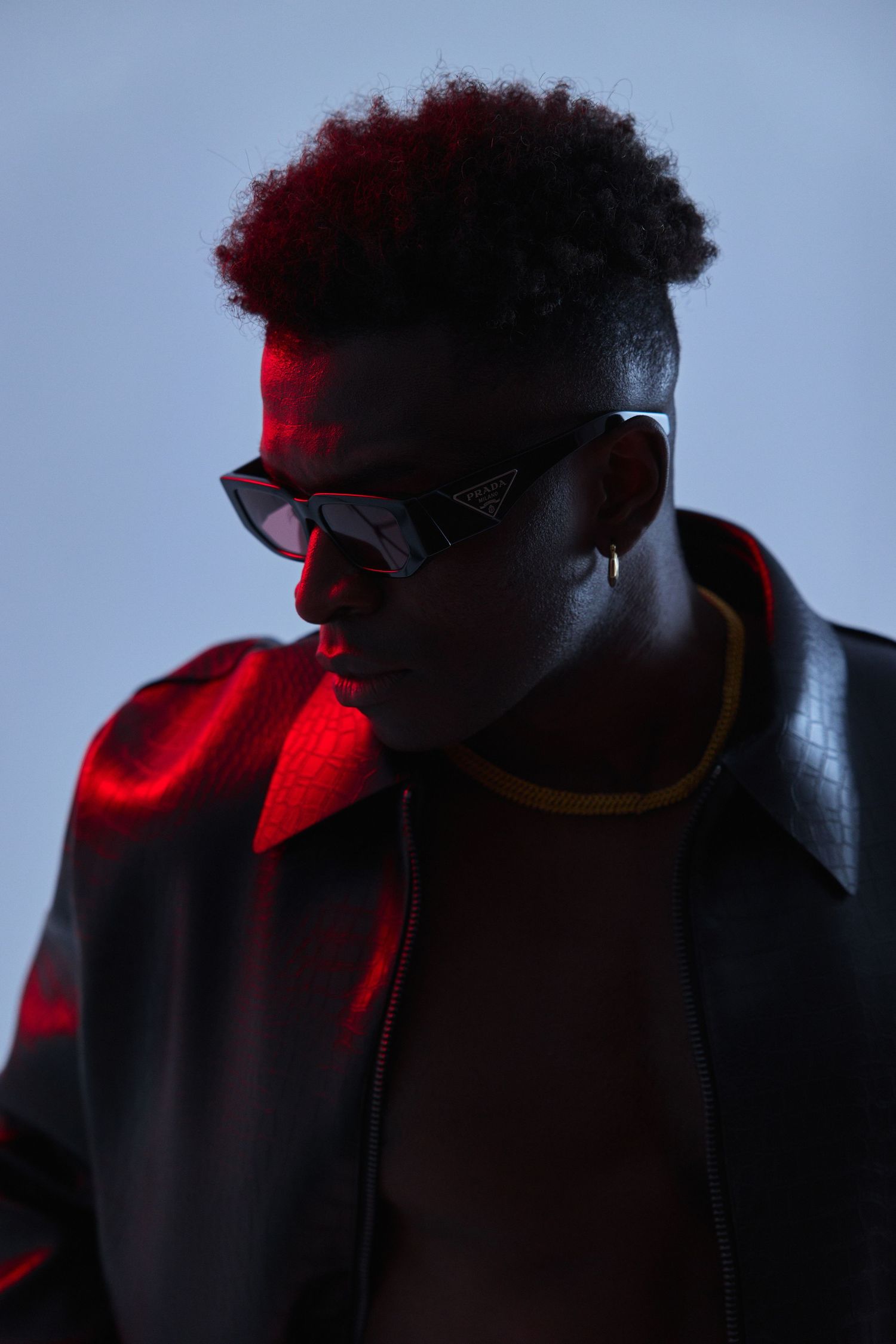 Silhouette profile shots with dramatic red lighting and dark shadows.