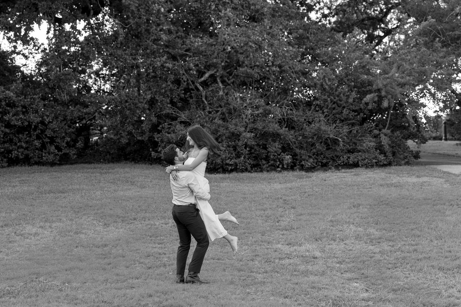 Black and white sequence of a couple dancing outdoors in a garden setting.