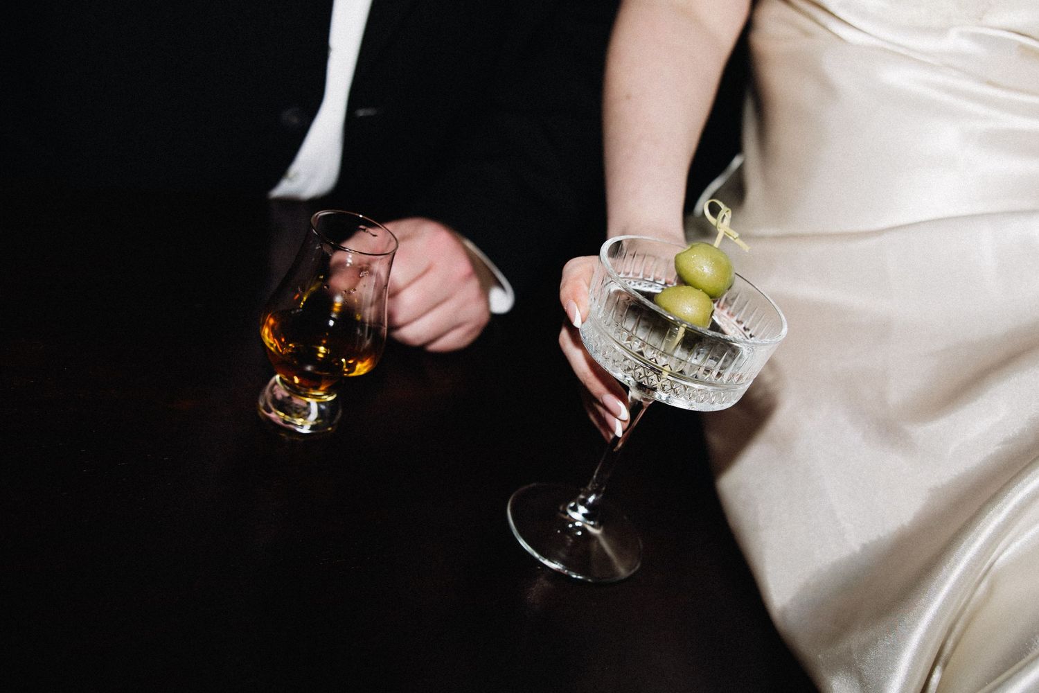Elegant glassware and drinks being served at a formal event.