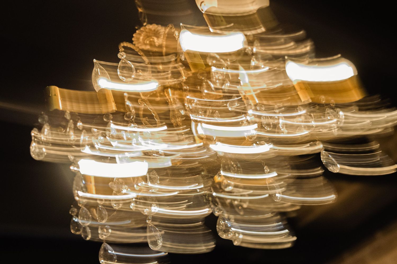 Illuminated glass light fixtures creating a warm ambient glow against dark background.