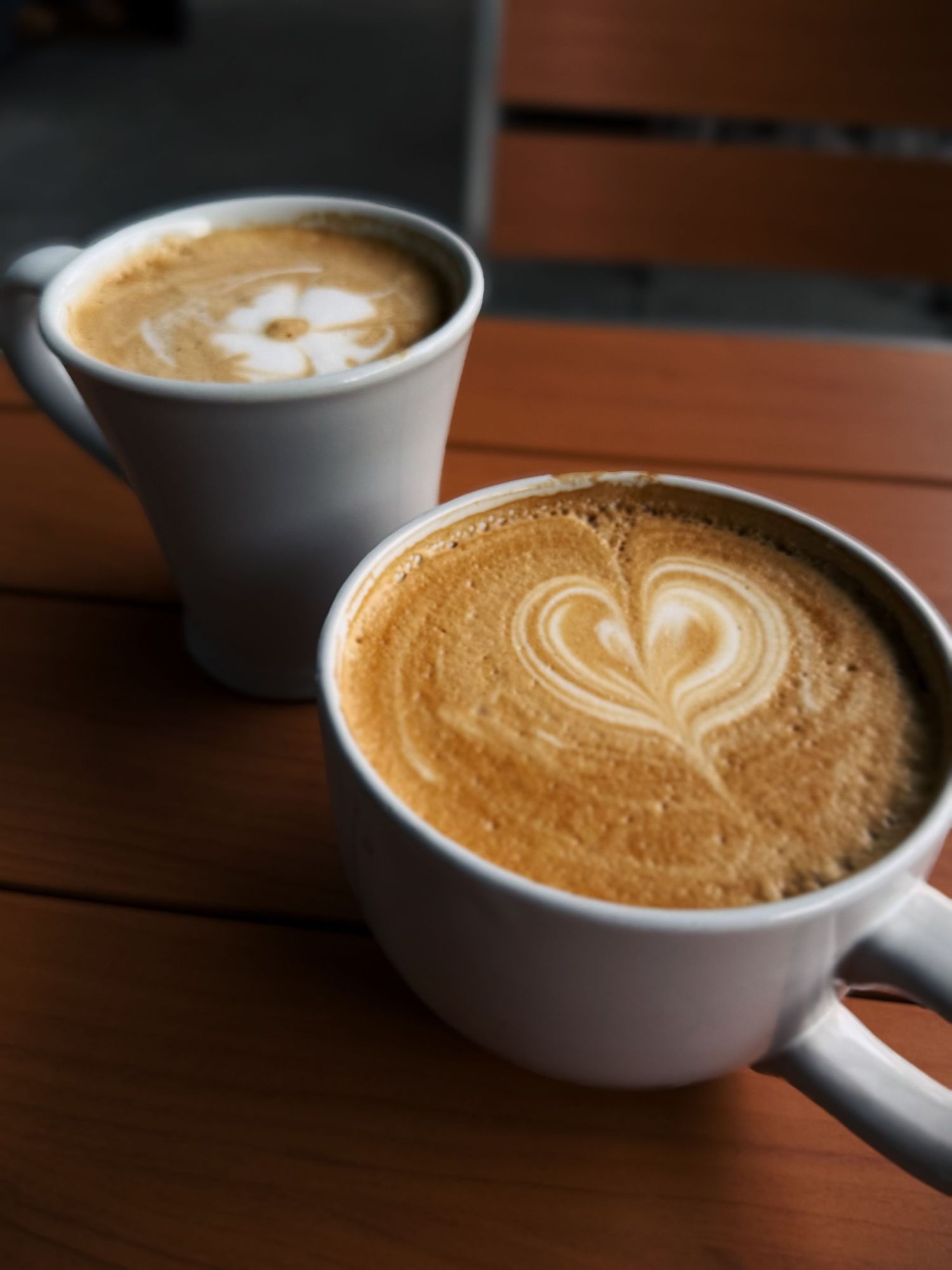 Latte art showing a heart design in white foam against golden coffee.