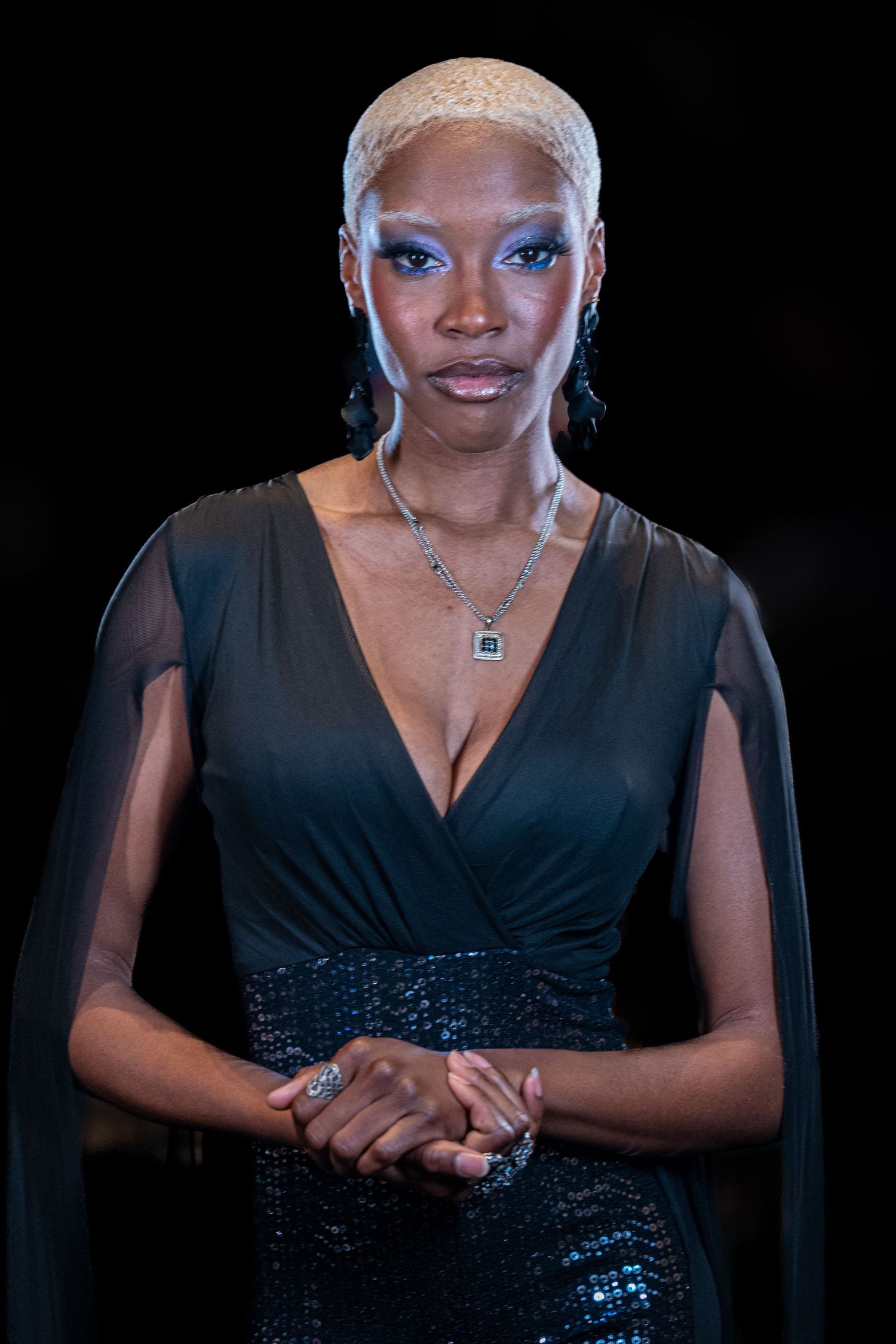 Portrait series showing a person in a black V-neck dress and blonde hair against a dark background.