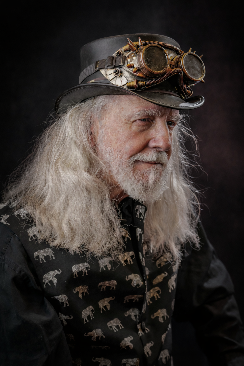 A profile portrait series shows someone with long white hair and a cap wearing steampunk goggles against a dark background.