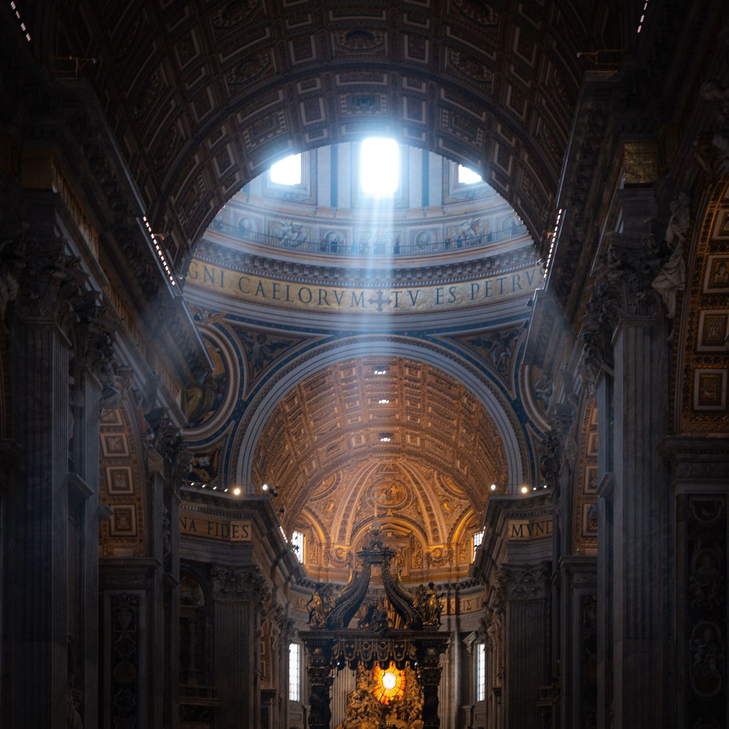 Interior of St. Peter's Basilica in Vatican City with dramatic light rays streaming through a dome window.