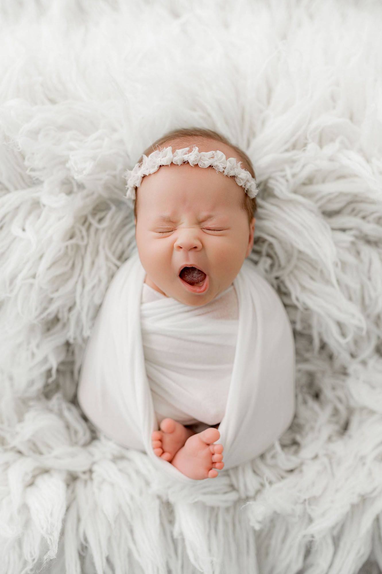 Infant yawning captured by Jacksonville baby photographer, Ashley Wilson