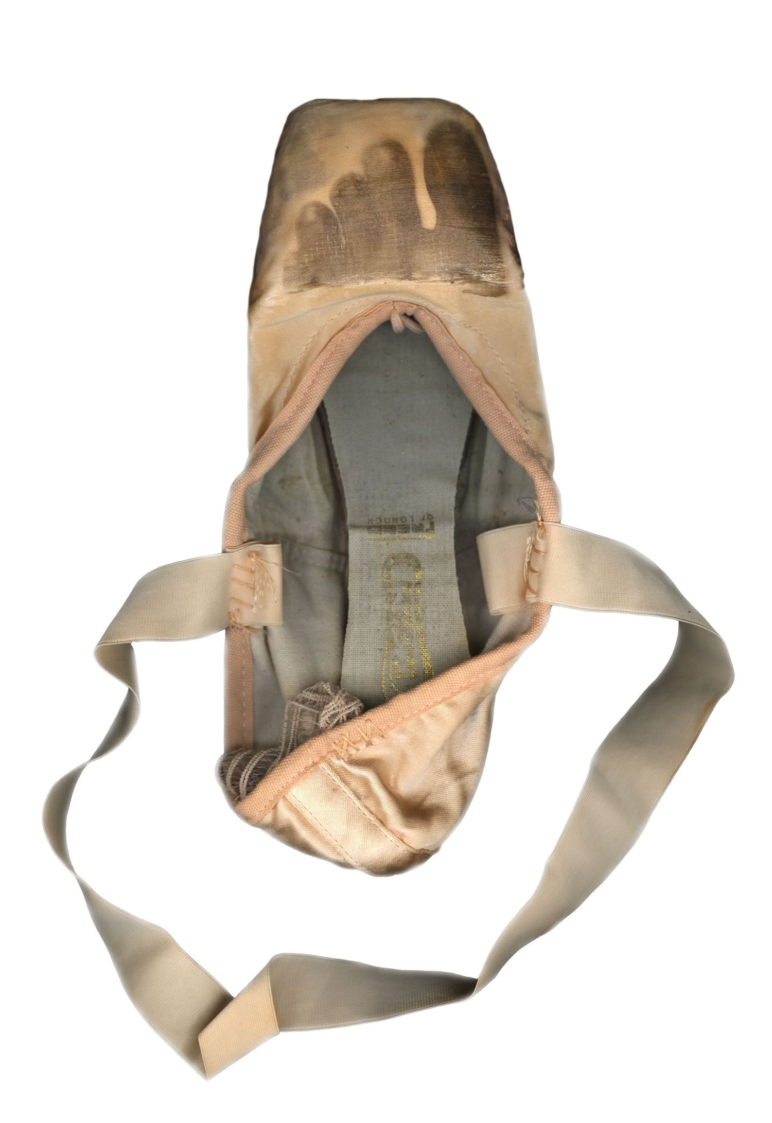 Minimalist Van Dyke Brown print on a pointe shoe. Focus on the raw sepia tones and tactile satin. Professional alternative process imagery.