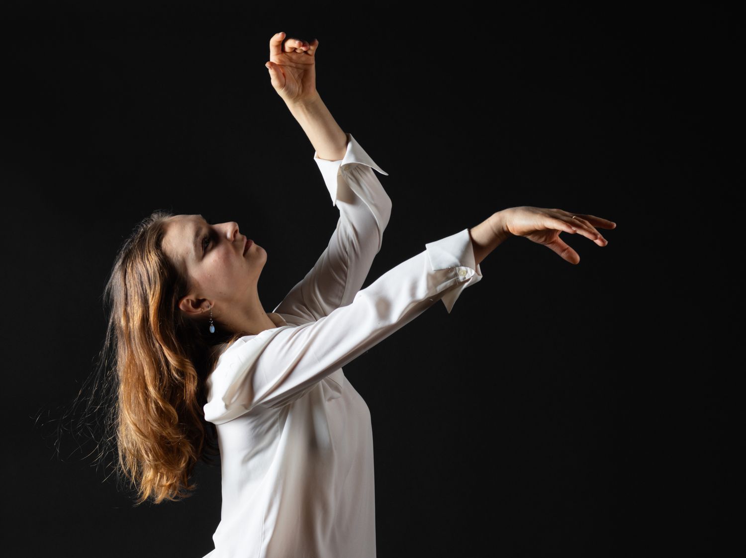 Professional contemporary dance photography. Dynamic movement and sculptural posing with dramatic studio lighting. Premium dancer imagery.