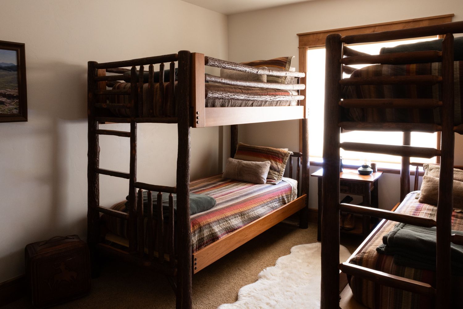 High-quality interior shot of a mountain retreat bedroom. Authentic lodge aesthetic. Perfect for travel websites and rental listings.