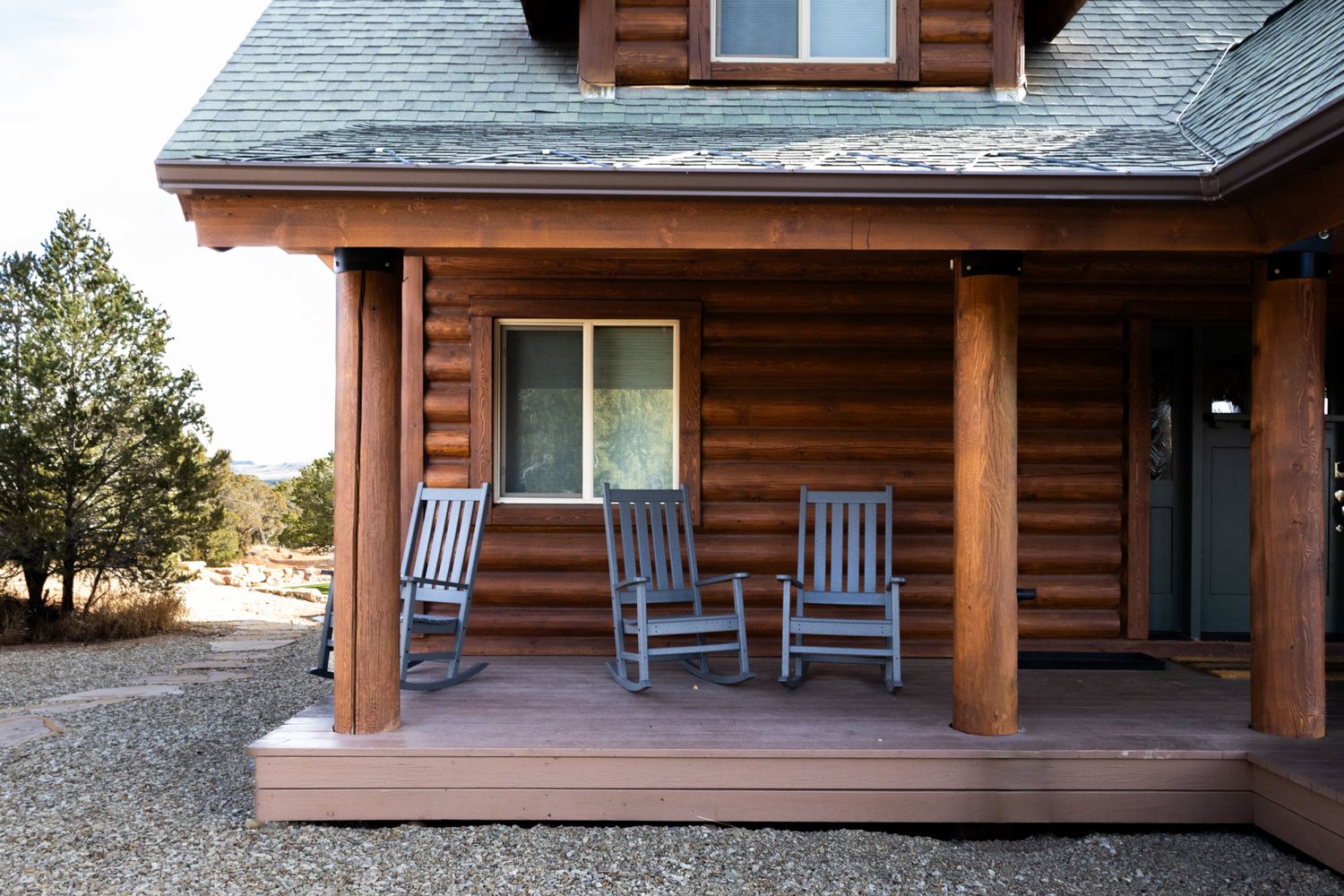 Scenic log home facade. Professional architectural photography of a mountain lodge. Ideal for travel marketing and rental listings.