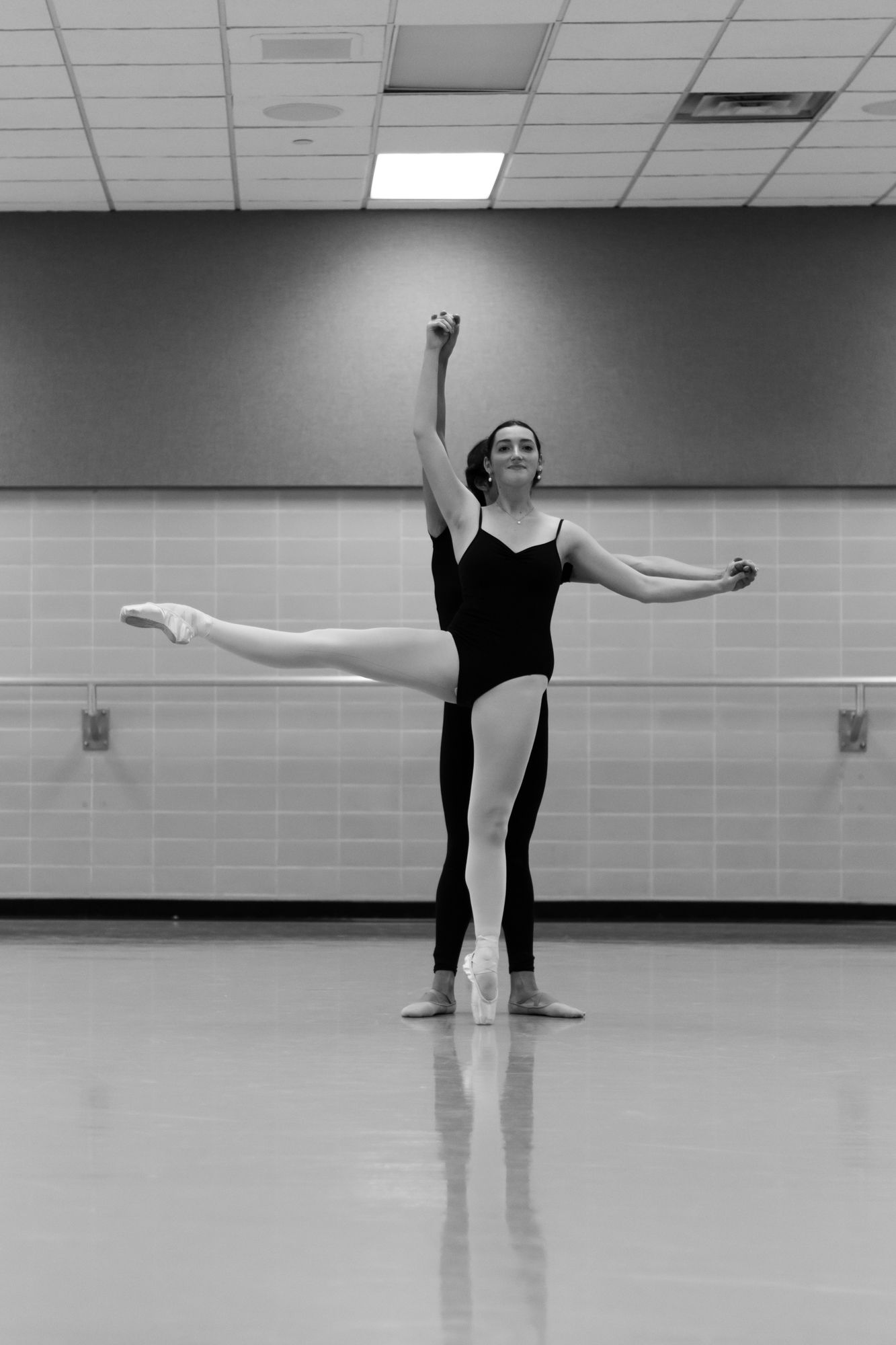 In perfect alignment. A black-and-white study of partnership and precision, where two forms become one seamless silhouette in the studio.