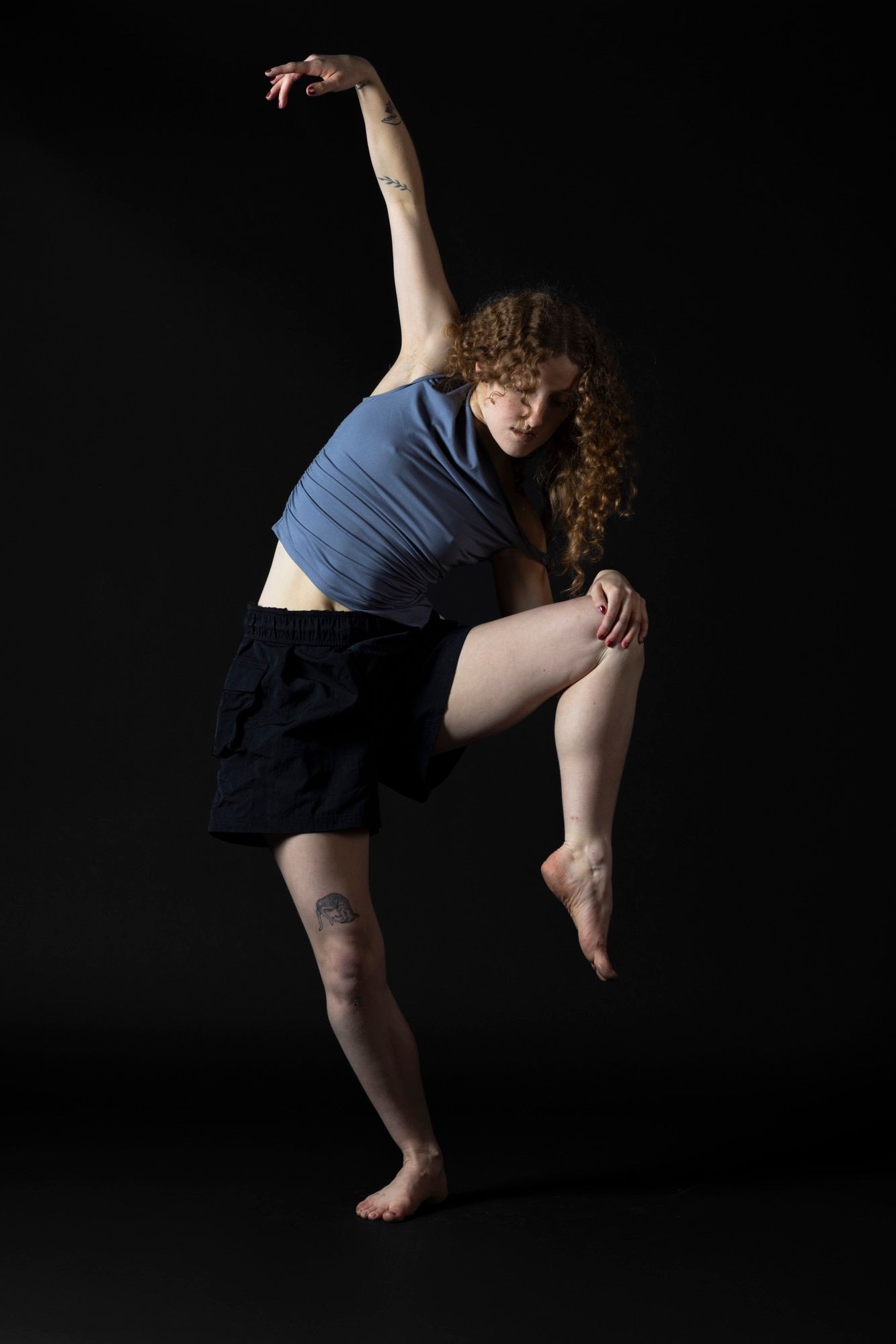 Professional contemporary dance photography. Dynamic movement and sculptural posing with dramatic studio lighting. Premium dancer imagery.