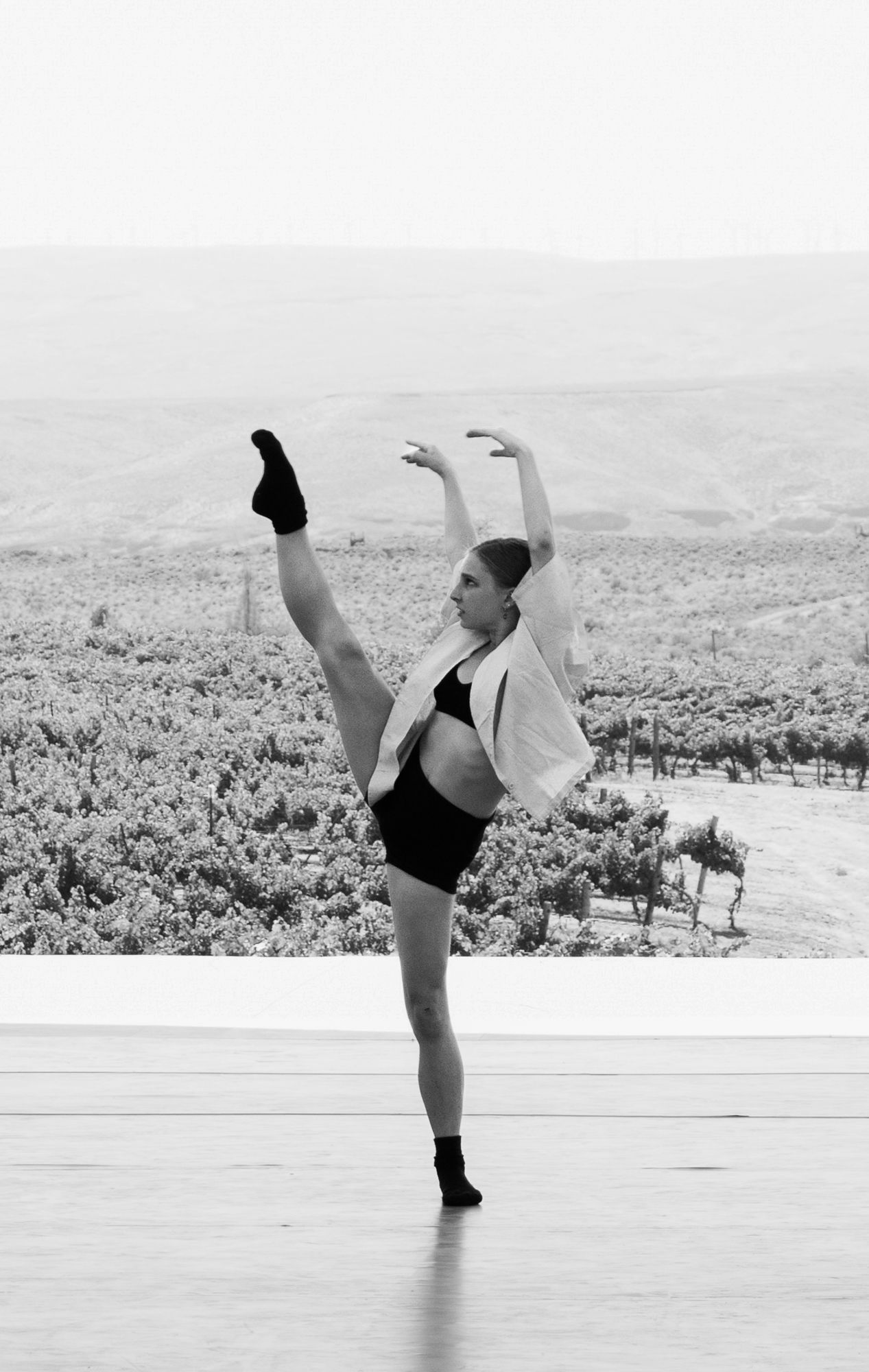 Elegant dance portraiture combining outdoor scenery with studio-grade technique. Professional B&W imagery for dancer branding and media.