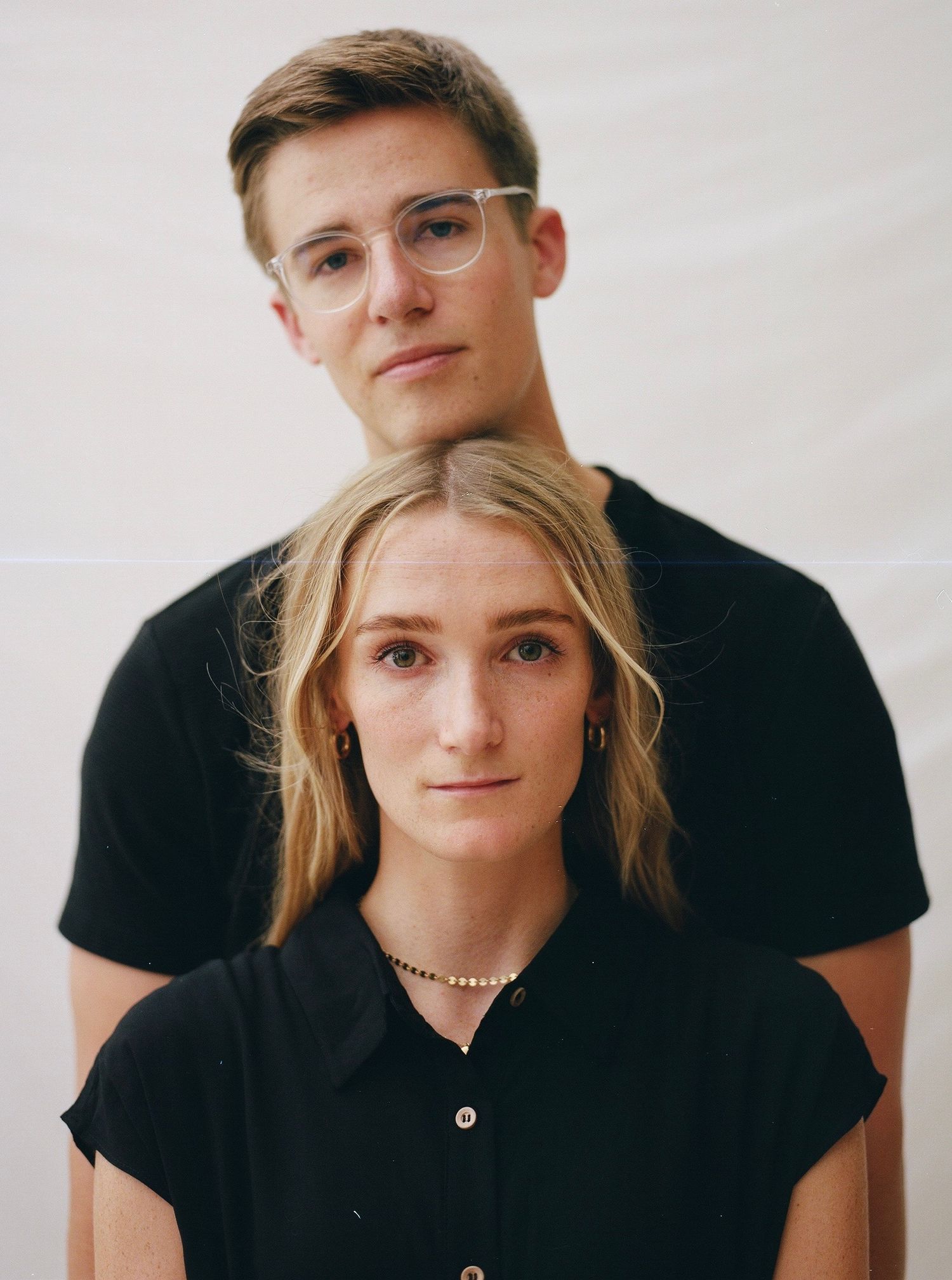 Clean, professional studio portrait of a couple with high-key lighting, ideal for minimalist lifestyle branding and editorial content.