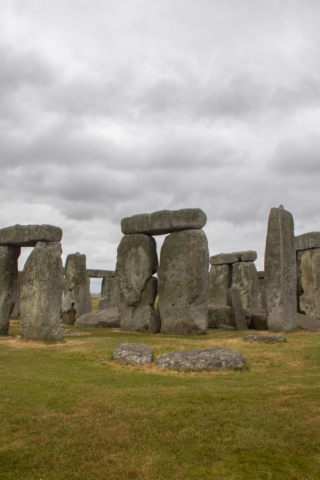 A study of Stonehenge’s inner circle. Focus on the jagged negative space between the massive trilithons. Atmospheric Neolithic imagery.