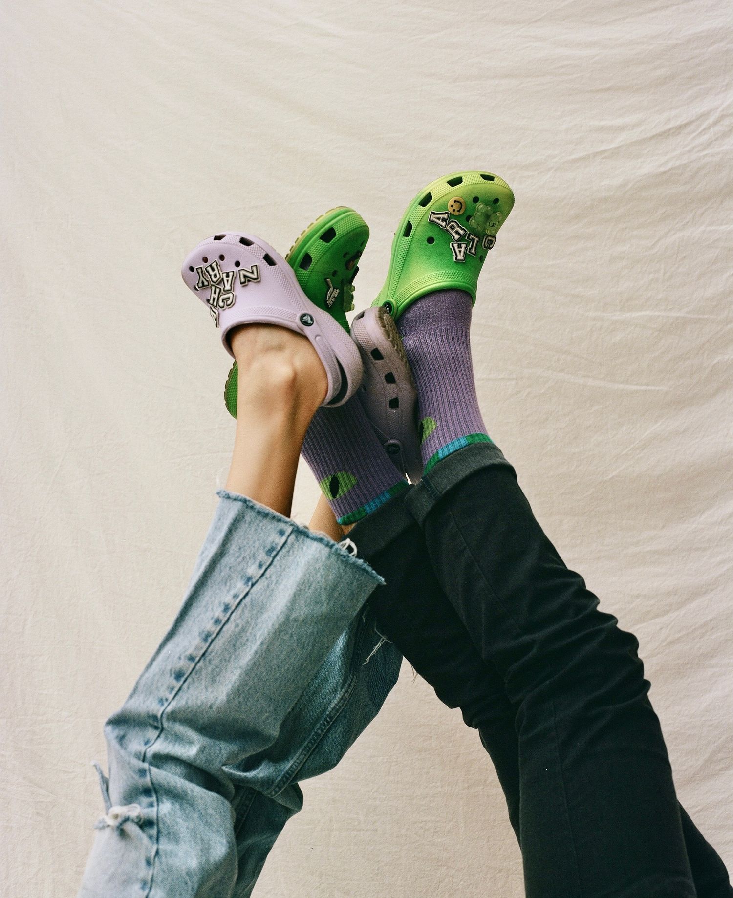 Fun, lifestyle footwear photography featuring vibrant clogs and patterned socks, perfect for youth-oriented fashion and social media